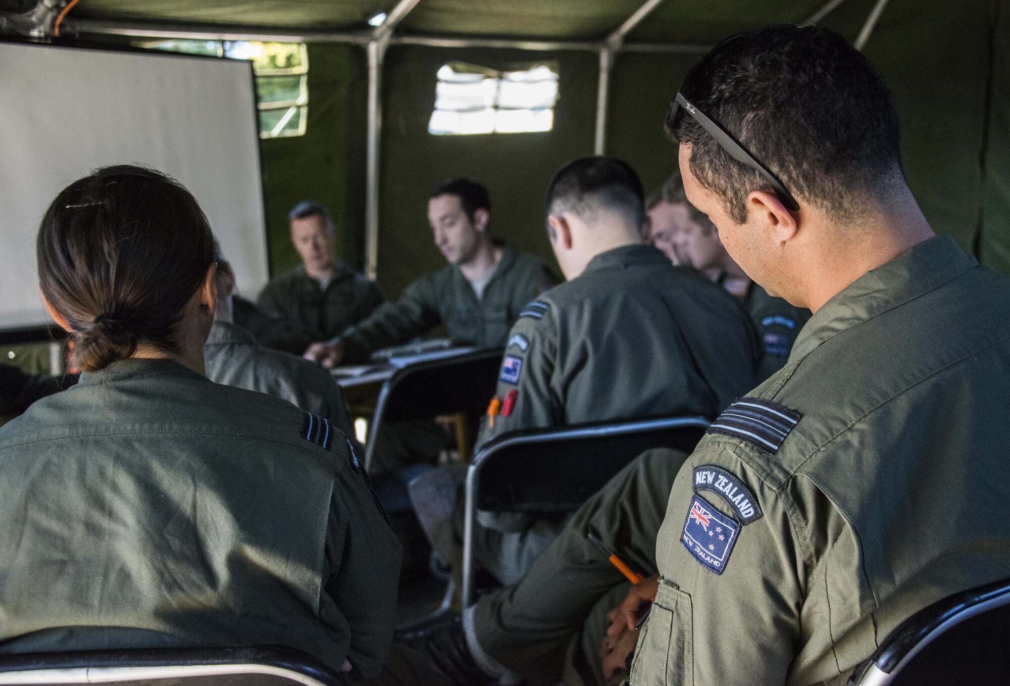 A U.S. Air Force 1st Special Operations Squadron evaluator navigator delivers a mission briefing to Royal New Zealand Air Force 40th Squadron and 1st SOS aircrew prior to formation flying operations, April 22, 2017 at RNZAF Base Woodbourne, New Zealand. The combined mission involving a formation flight with two U.S. Air Force MC-130s and one RNZAF C-130 demonstrated the strength of the alliance between the United States and New Zealand (U.S. Air Force photo by Capt. Jessica Tait)