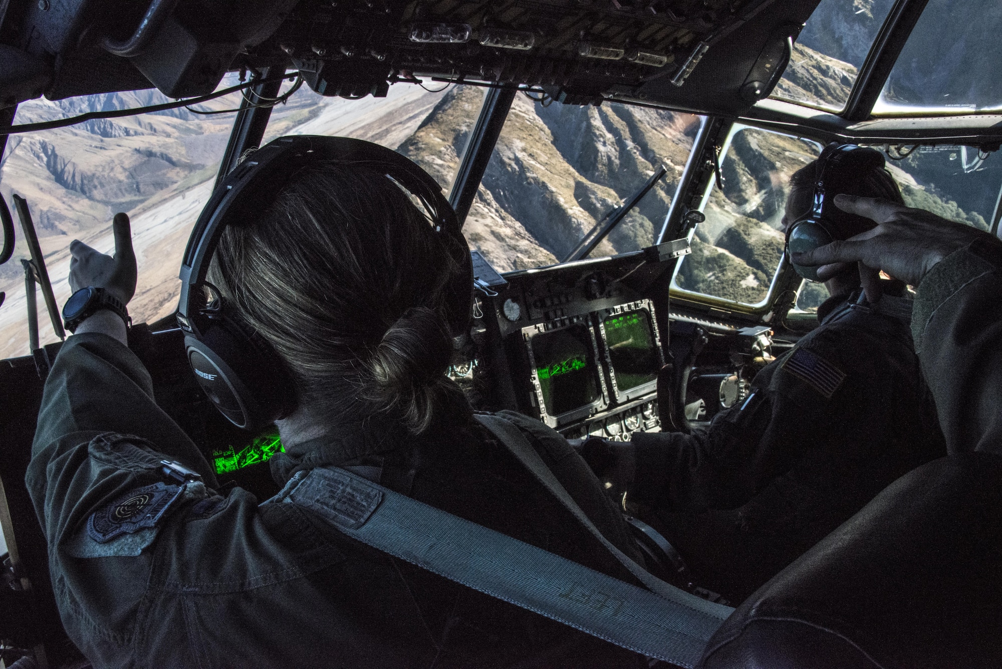 U.S. Air Force 1st Special Operations Squadron pilots looks out the window of a U.S. Air Force MC-130H Combat Talon II during a formation flight with Royal New Zealand Air Force 40th Squadron, April 22, 2017 at RNZAF Base Woodbourne, New Zealand. Exercise Teak Net provided the opportunity at further developing interoperability with counterparts from the RNZAF through daily airborne operations to include low-level formation work and tactical operations on night vision goggles. (U.S. Air Force photo by Capt. Jessica Tait)