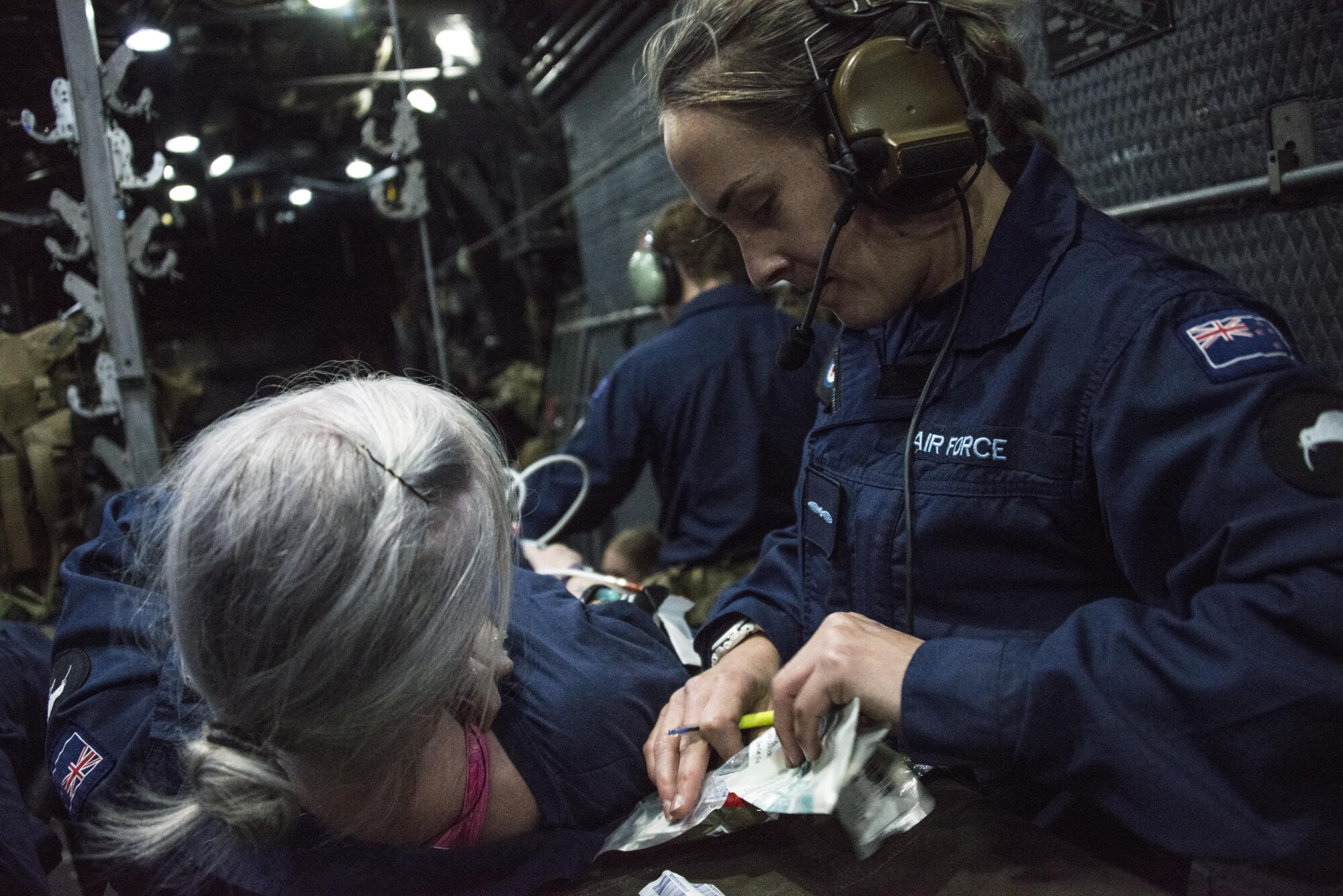 A Royal New Zealand Air Force medic assesses a patient during a casualty evacuation (CASEVAC) exercise, April 26, 2017 at RNZAF Base Woodbourne, New Zealand. The U.S. Air Force Special Operations Forces Medical Element (SOFME) medics conducted a subject-matter expert exchange with RNZAF medics during Exercise Teak Net, which culminated with a low-light, low-level CASEVAC. (U.S. Air Force photo by Capt. Jessica Tait)