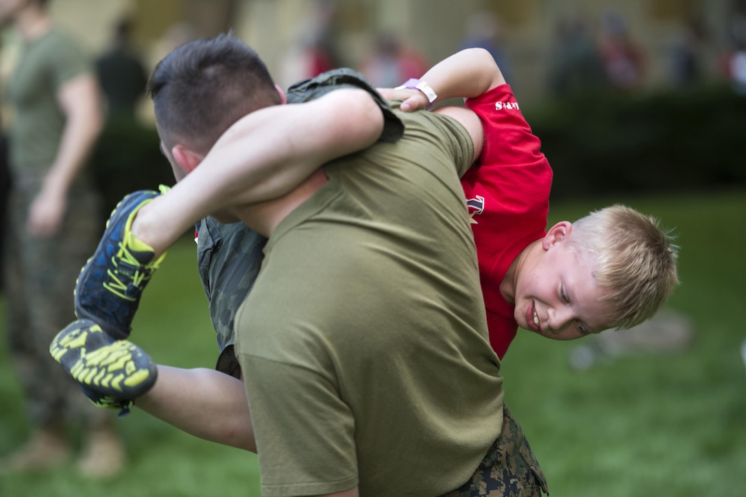 Seven-year-old Orion Clarkson tries to tackle Marine Cpl. Skylar Heidrich during a Marine martial arts demonstration