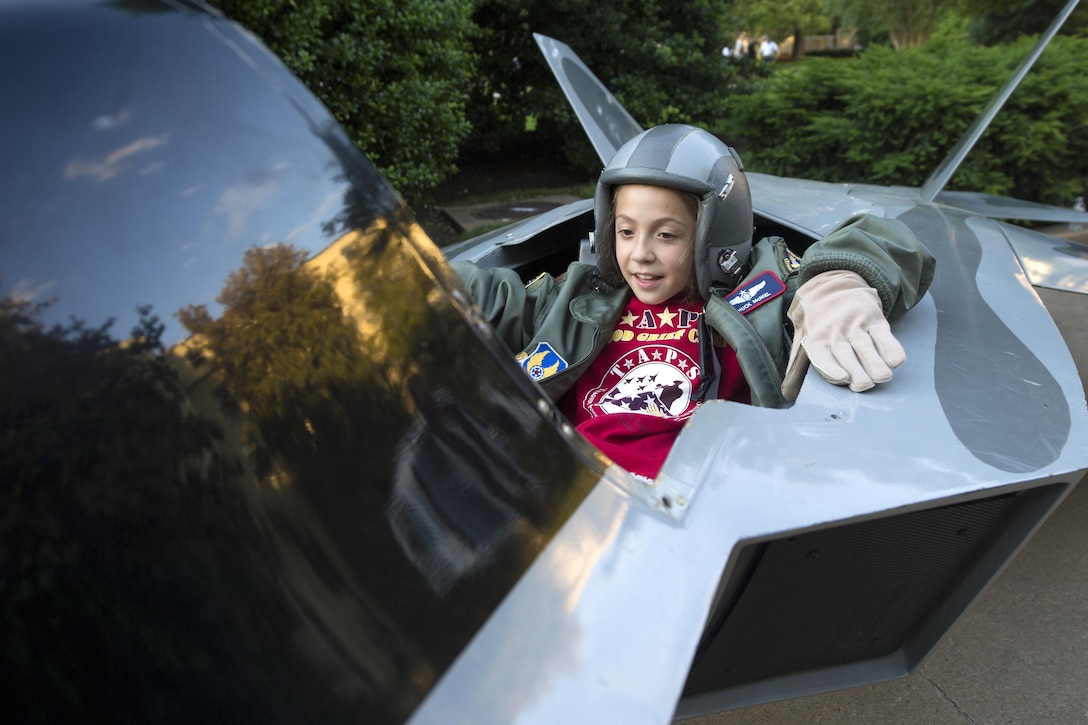 Alyssa Suzch plays in a model F-22 airplane while attending the annual Tragedy Assistance Program for Survivors event at the Pentagon, May 26, 2017. DoD photo by EJ Hersom