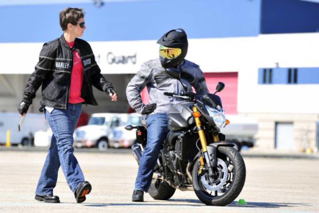Lt. Katherine Voth, a pilot at Coast Guard Air Station Atlantic City, N.J., instructs a student during a motorcycle safety course, Aug. 26, 2014. The course is a requirement for Coast Guardsmen who operate motorcycles. Coast Guard photo by Petty Officer 2nd Class Cynthia Oldham