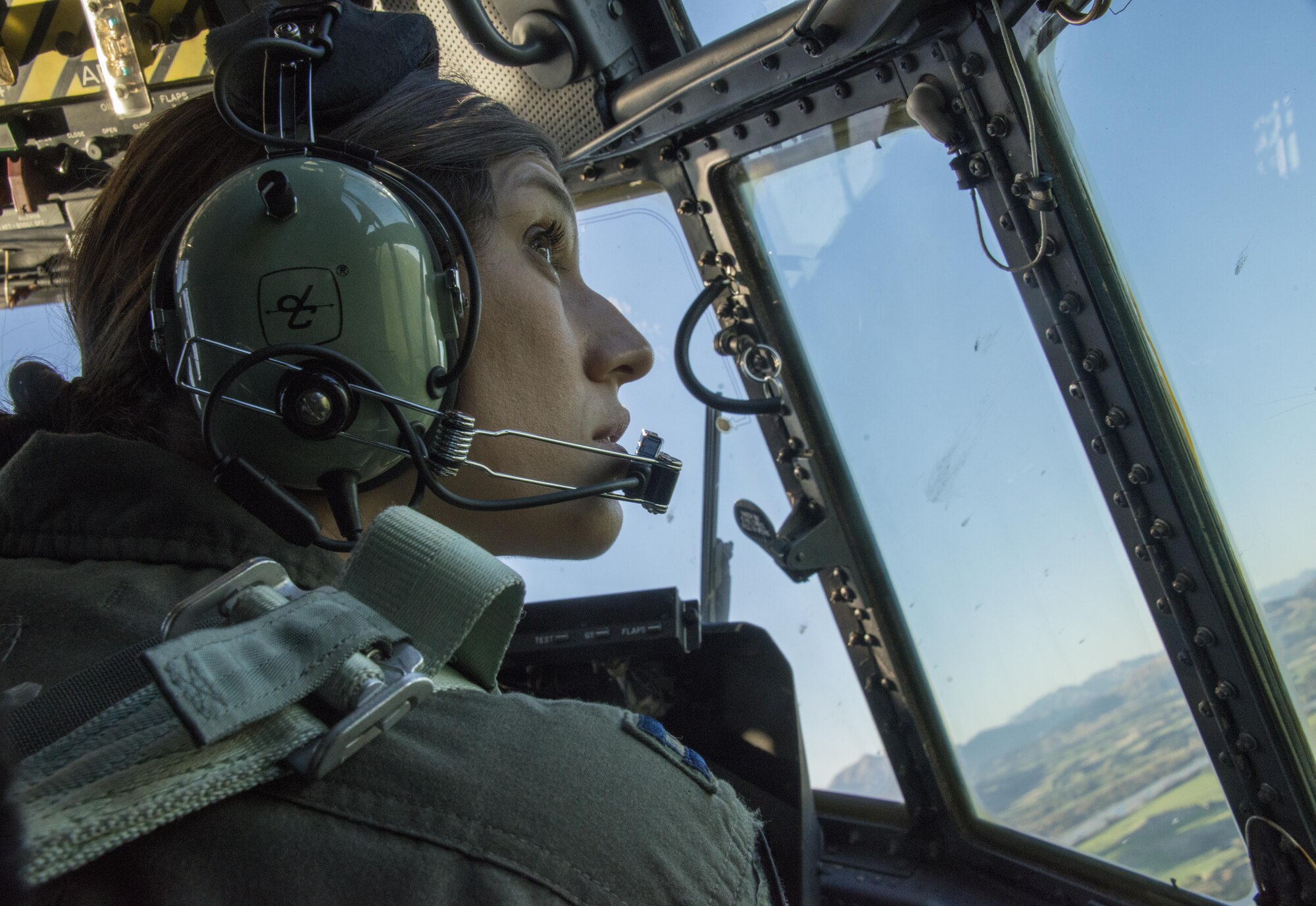 A U.S. Air Force 1st Special Operations Squadron pilot looks out the window of a U.S. Air Force MC-130H Combat Talon II during a formation flight with Royal New Zealand Air Force 40th Squadron, April 22, 2017 at RNZAF Base Woodbourne, New Zealand. Exercise Teak Net provided the opportunity at further developing interoperability with counterparts from the RNZAF through daily airborne operations to include low-level formation work and tactical operations on night vision goggles. (U.S. Air Force photo by Capt. Jessica Tait)