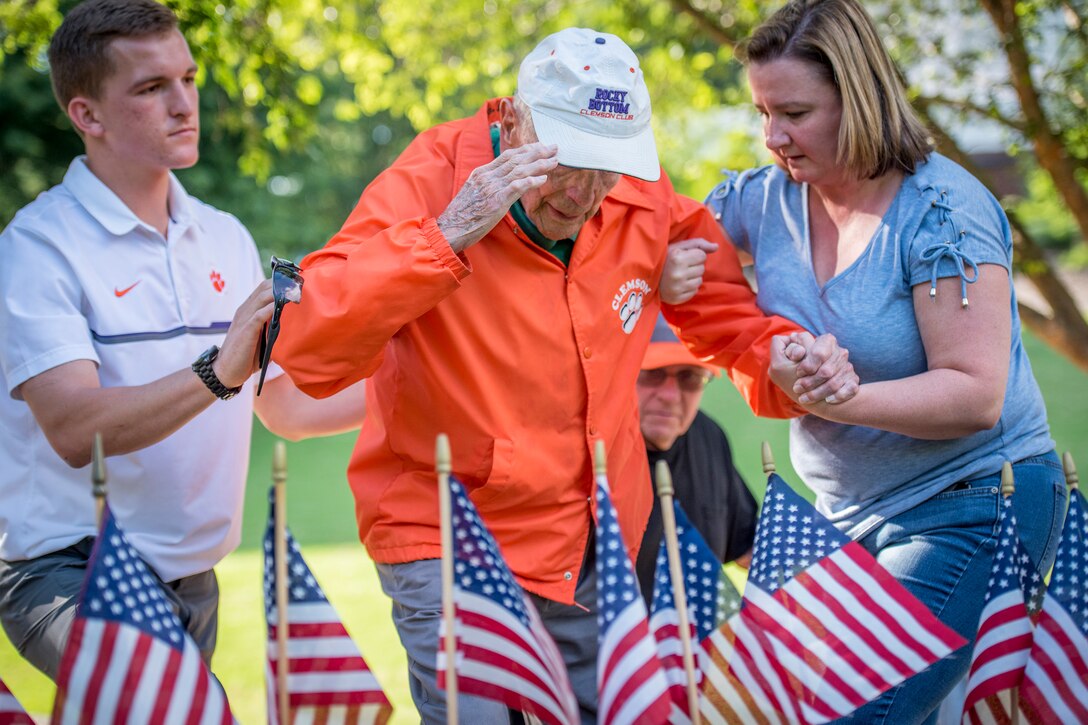 Retired Army Col. Ben Skardon, 99, a survivor of the Bataan Death March, salutes Henry Leitner’s headstone in Clemson University’s Scroll of Honor during a flag-placing ceremony in preparation for Memorial Day observances, May 25, 2017. Leitner and Skardon, both Clemson alumni, survived the infamous Bataan Death March and were prisoners of war together. Army Reserve photo by Staff Sgt. Ken Scar