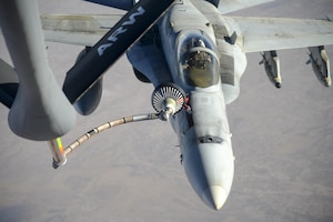 A U.S. Navy F/A-18C from the Strike Fighter Squadron VFA-37 Ragin' Bulls receives fuel in flight from a U.S. Air Force KC-135 Stratotanker over Southwest Asia May 21, 2017. Assigned to the 340th Expeditionary Air Refueling Squadron, out of Al Udeid Air Base, Qatar, the tanker from the 186th Air Refueling Wing, Mississippi Air National Guard was fitted with a drogue attached to the boom, for specialized receiver equipment on Navy and coalition aircraft. The 340th EARS maintains a 24/7 presence in the AOR, extending the missions of aircraft supporting Operation Inherent Resolve and the fight against ISIS. (U.S. Air National Guard photo by Master Sgt. Andrew J. Moseley/Released)