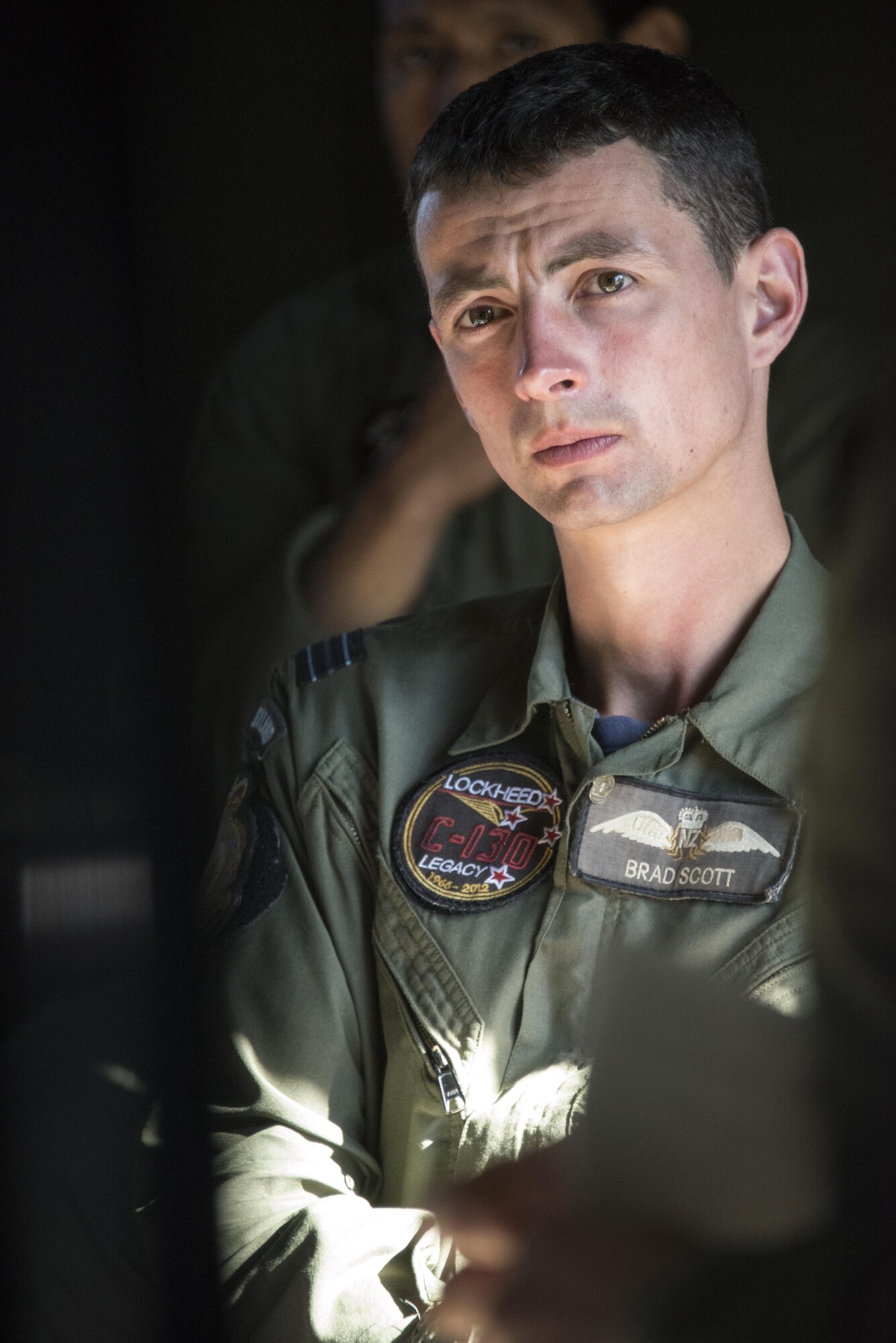A Royal New Zealand Air Force 40th Squadron pilot listens during the mission briefing delivered by U.S. Air Force 1st Special Operations Squadron aircrew, April 27, 2017 at RNZAF Base Woodbourne, New Zealand. The combined mission involving a formation flight with two U.S. Air Force MC-130s and one RNZAF C-130 demonstrated the strength of the alliance between the United States and New Zealand. (U.S. Air Force photo by Capt. Jessica Tait)