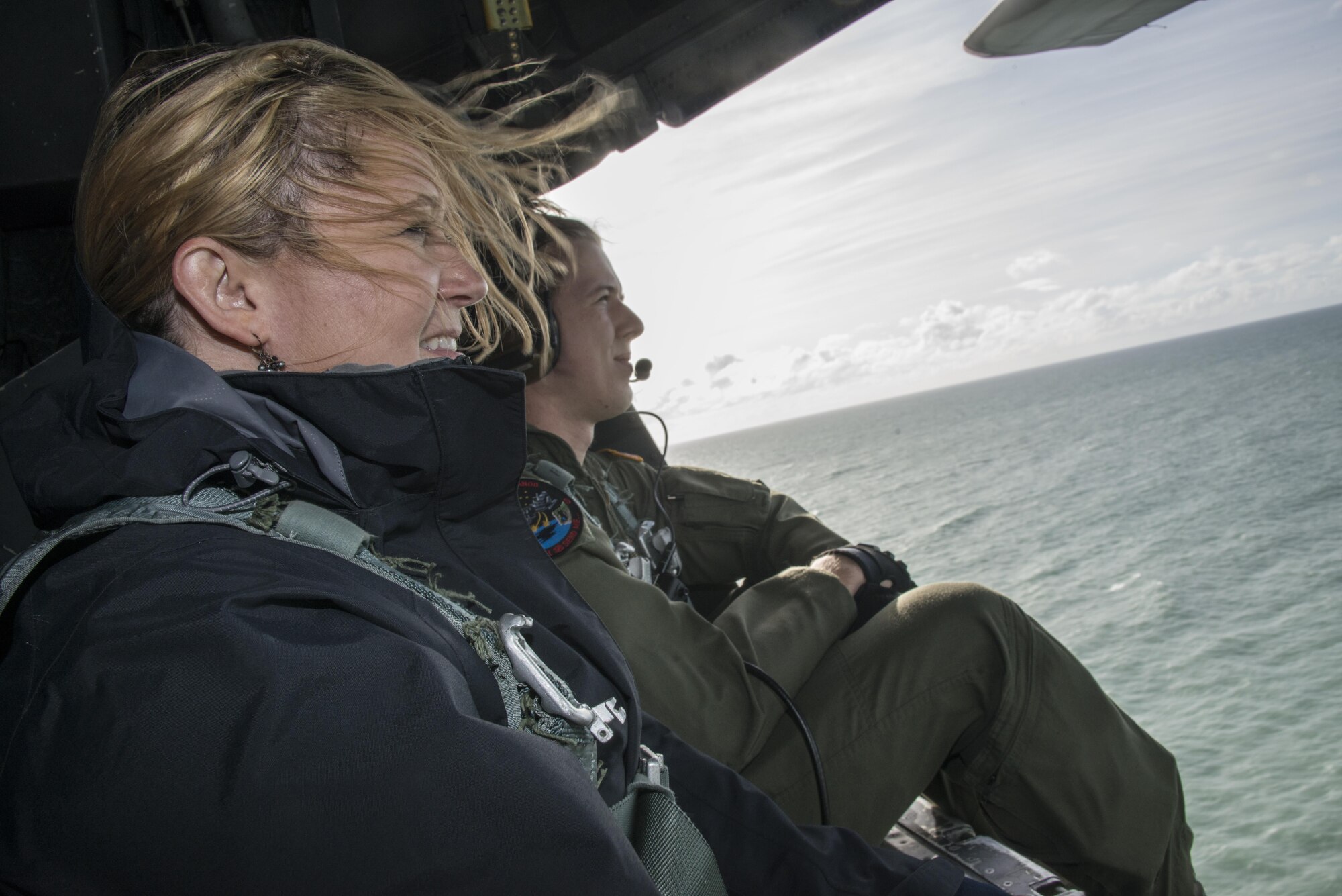 A U.S. Embassy New Zealand staffer enjoys the view out the back of a U.S. Air Force MC-130H Combat Talon II assigned to the 1st Special Operations Squadron during an observation flight, April 19, 2017 at Royal New Zealand Air Force Base Woodbourne, New Zealand. Members of the 353rd Special Operations Group and RNZAF 40th Squadron showcased the military cooperation efforts between the U.S. and New Zealand militaries during a visit by U.S. Embassy New Zealand’s Chargé d'Affaires and staffers, April 19-20, 2017. (U.S. Air Force photo by Capt. Jessica Tait)
