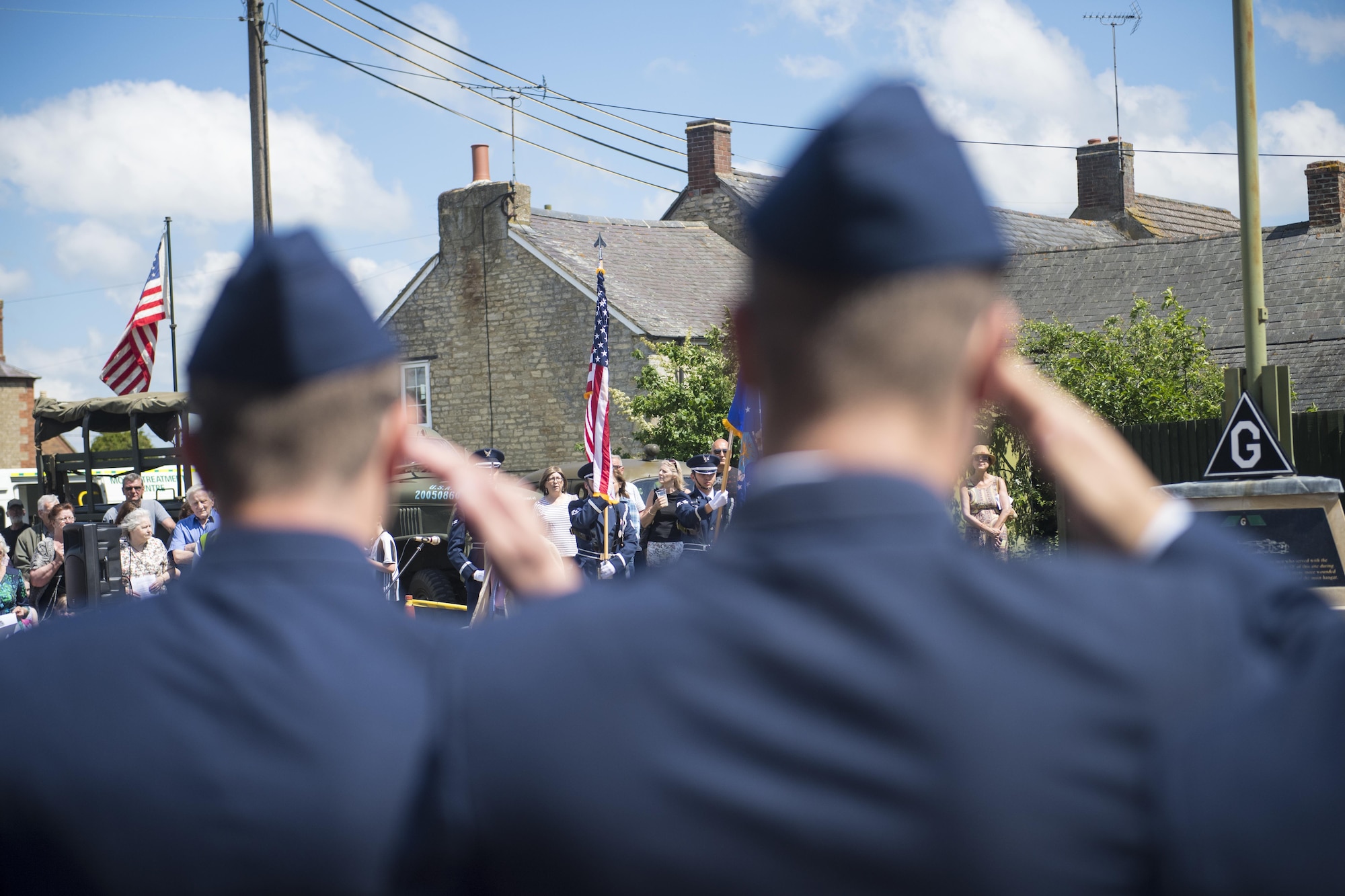 Airmen form the 305th Air Mobility Wing at Joint Base McGuire-Dix-Lakehurst, New Jersey, salute the U.S. flag during a rededication ceremony of their predecessor unit the 305th Bombardment Group in Chelveston, England on May 27. Twenty members of the 305th AMW attended the ceremony alongside many of the Chelveston residents. (U.S. Air Force photo by Senior Airman Joshua King)