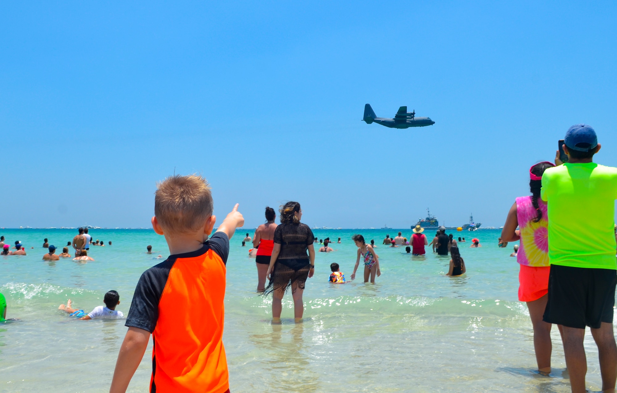 Spectators view an aerial demonstration during the National Salute to America’s Heroes Air and Sea Show, May 28, 2017, at Miami Beach, Fla. Top tier U.S. military assets assembled in Miami to showcase air superiority while honoring those who have made the ultimate sacrifice during the Memorial Day weekend. (U.S. Air Force photo/Senior Airman Brandon Kalloo Sanes)