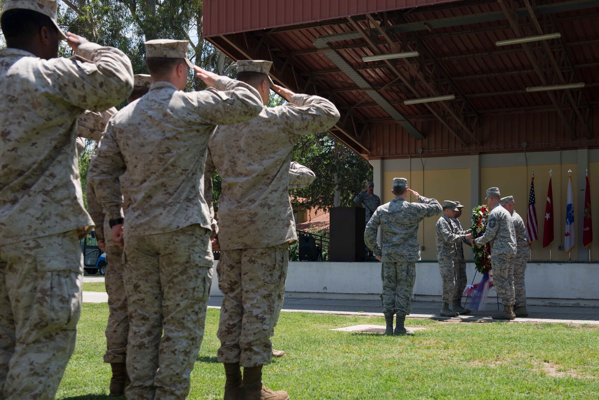 Members of the 39th Air Base Wing, salute while a wreath is laid during a Memorial Day Ceremony May 26, 2017, at Incirlik Air Base, Turkey. The laying of the wreath is done in memory of United States military members who paid the ultimate sacrifice. This marked the first joint service ceremony at Incirlik. (U.S. Air Force photo by Airman 1st Class Devin M. Rumbaugh)