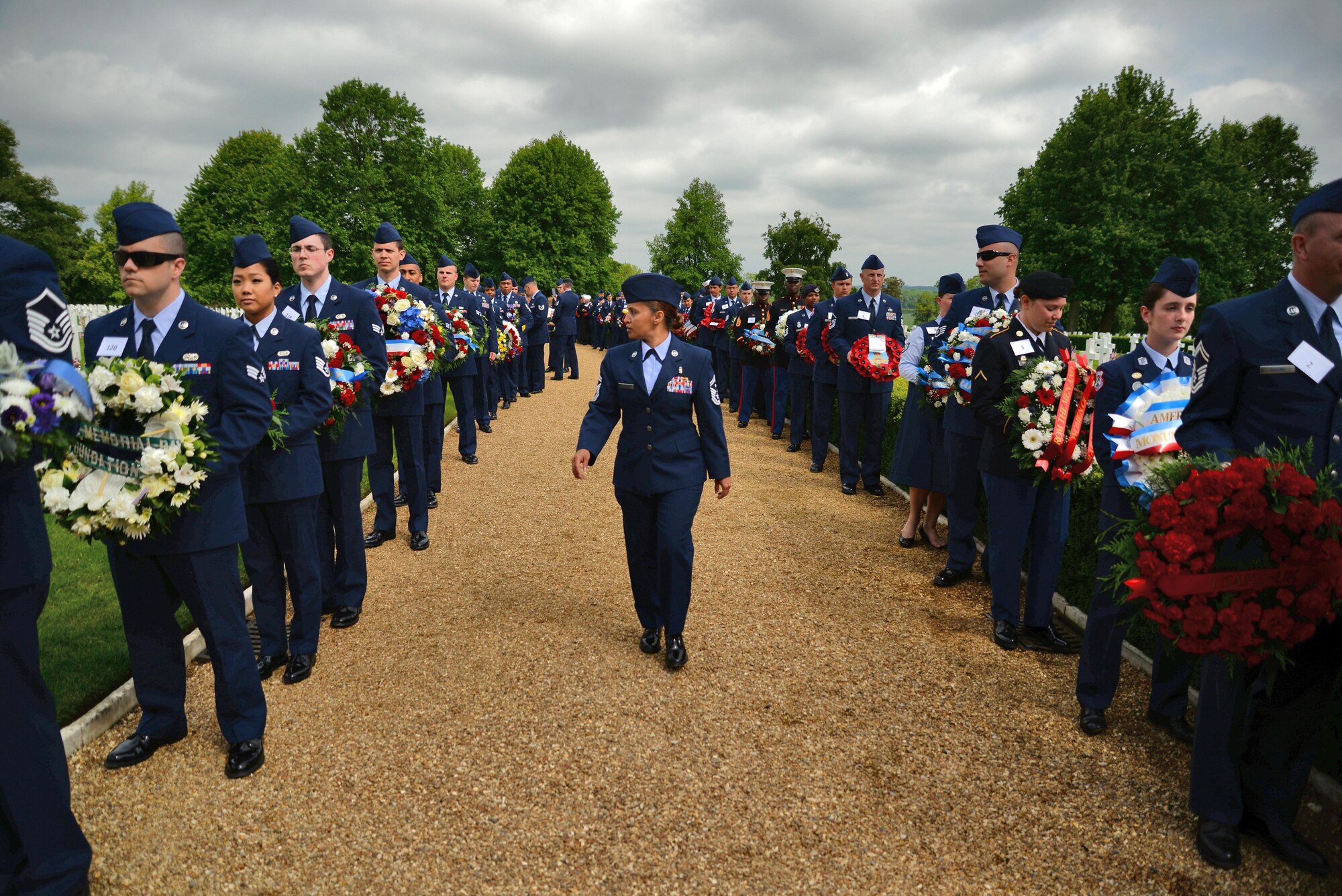 U.S. Air Force Senior Master Sgt. Arwa Cavendar, 100th Aircraft Maintenance Squadron first sergeant, provides a pre-ceremony inspection prior to the Madingley Memorial Day Ceremony May 29, 2017, at Madingley Memorial Cemetery in Cambridge, England. The event included a wreath laying, fly overs and a firing of volleys. (U.S. Air Force photo by Senior Airman Christine Groening) 