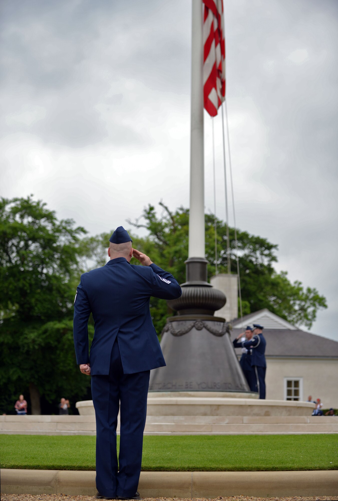 A U.S. Air Force Master Sgt. salutes the U.S. flag during the Madingley Memorial Day ceremony May 29, 2017, at Madingley Memorial Cemetery in Cambridge, England. The Memorial Day ceremony included keynote speakers, wreath laying and fly-overs. (U.S. Air Force photo by Senior Airman Christine Groening) 