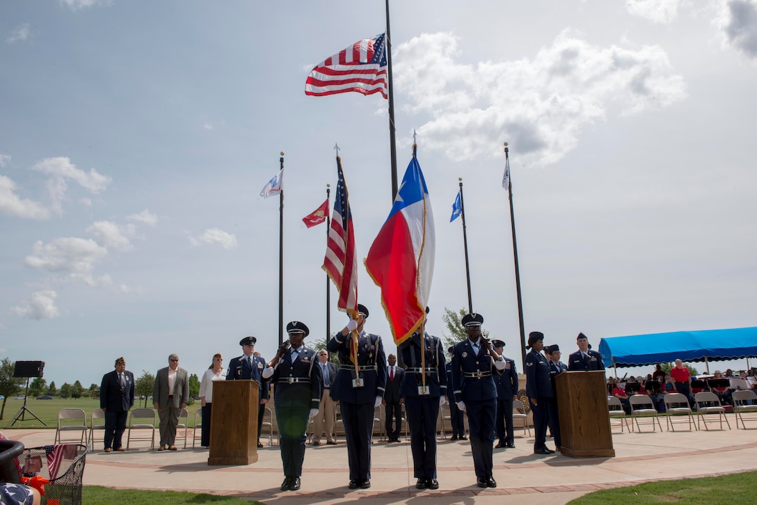 The Dyess Honor guard presents the colors during a Memorial Day ceremony at the Texas State Veterans Cemetery, Abilene, Texas, May 29, 2017. The ceremony consisted of remarks by the 7th Bomb Wing Commander, Col. David Benson, presentation of colors, national anthem, a fly-over by the Commemorative Air Force, introduction of Gold Star families, the playing of taps and a firing party. (U.S. Air Force photo by Senior Airman Austin Mayfield)