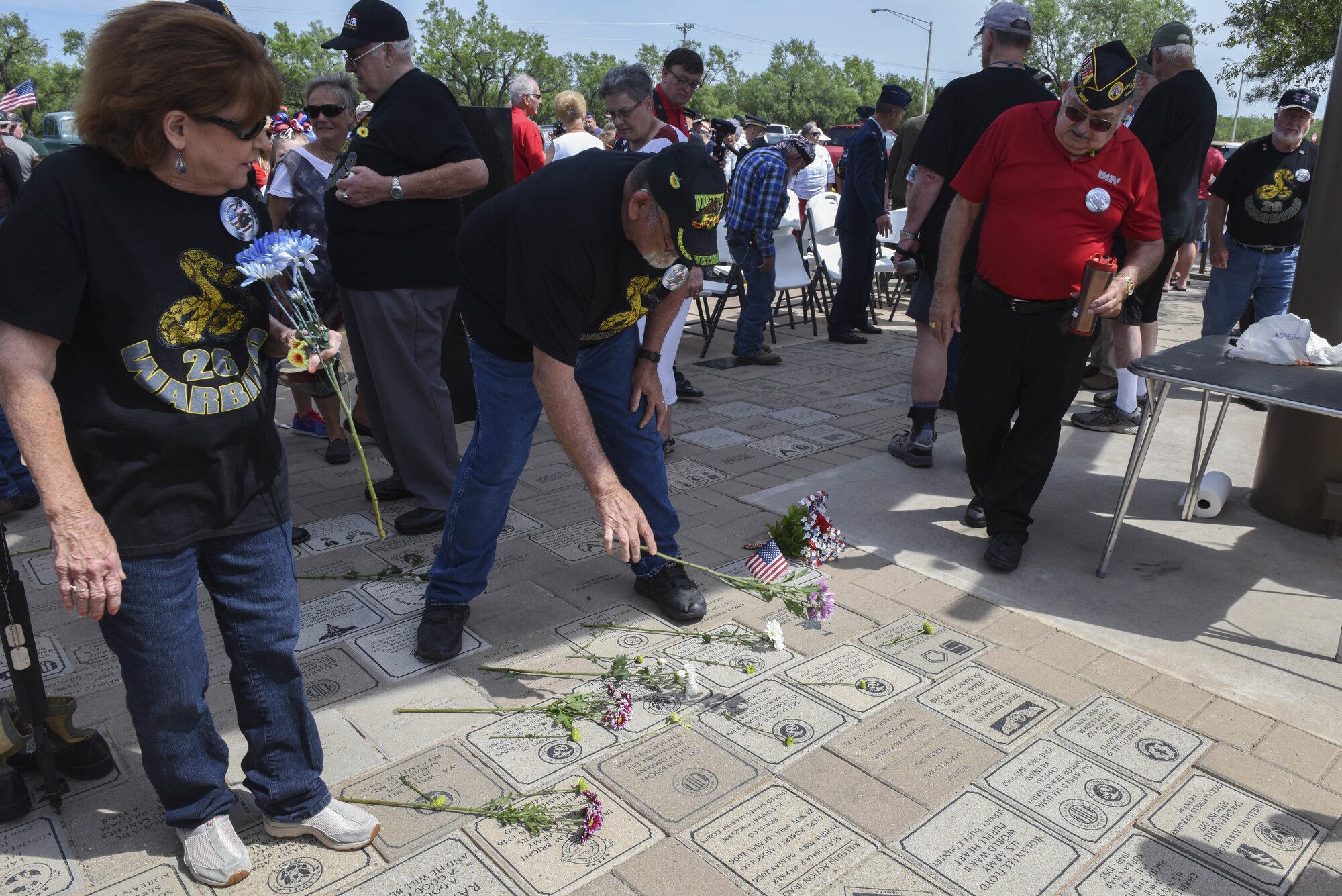 Tom Bright, Vietnam Veterans of America Chapter 457 president, lays a flower on a memorial stone at the San Angelo Regional Airport, Texas, May 29, 2017. The flowers were part of a ceremony to honor the fallen veterans of the Vietnam and other conflicts. (U.S. Air Force photo by Airman 1st Class Chase Sousa/Released)