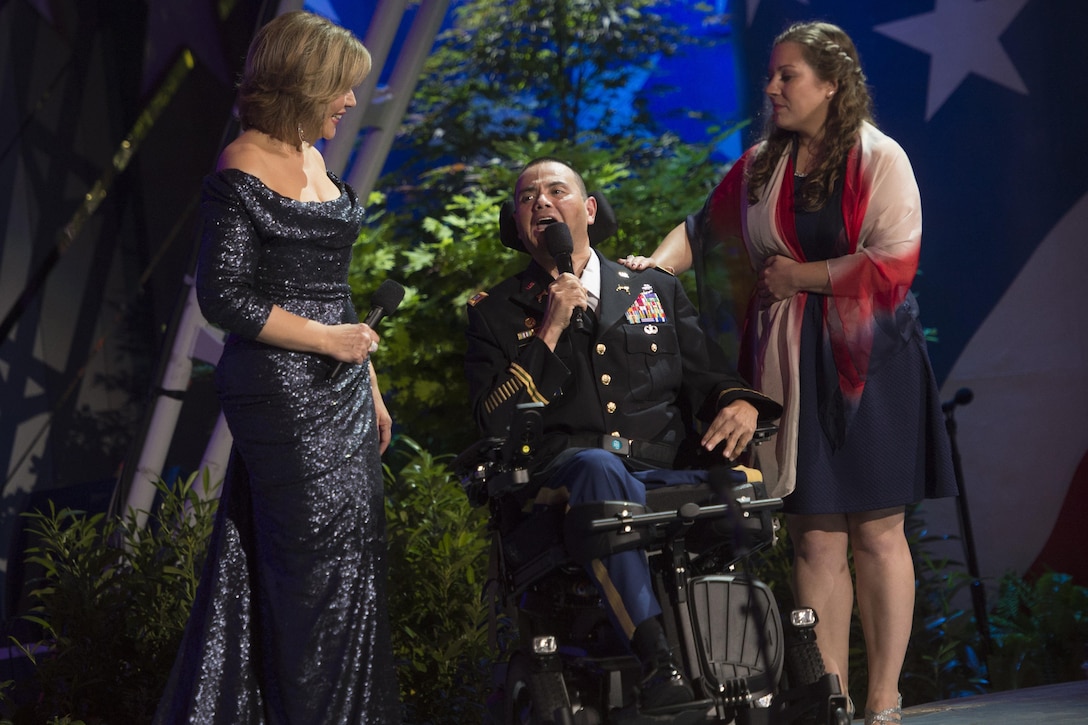 Army Capt. Luis Avila, a military policeman severely injured after an IED explosion, performs alongside his music therapist Rebecca Vaudeuil and opera singer Renée Fleming