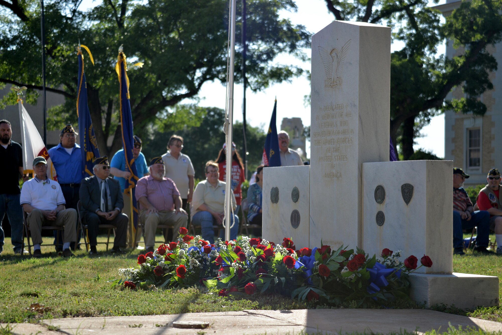Flowers and wreaths adorn the veteran memorial during the Memorial Day ceremony at the Tom Green County Courthouse in San Angelo, Texas, May 29, 2017. The ceremony paid tribute to those who have lost their lives in all branches of the military. (U.S. Air Force photo by Airman 1st Class Randall Moose/Released)