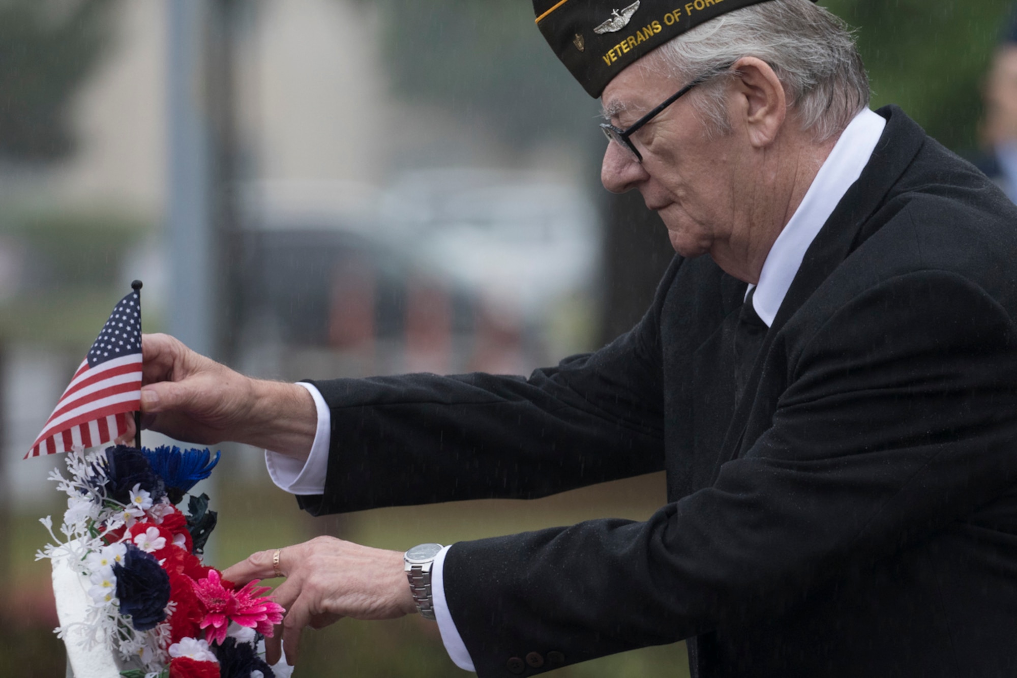 Retired U.S. Air Force Master Sgt. Bill Bilyk, Vietnam War veteran and member of the Veterans of Foreign War Post 9555, presents the American flag to the wreath during the Memorial Day ceremony at Yokota Air Base, Japan, May 26, 2016. The 374th Airlift Wing hosted the ceremony in memory of those who made the ultimate sacrifice during military service. (U.S. Air Force photo by Yasuo Osakabe)