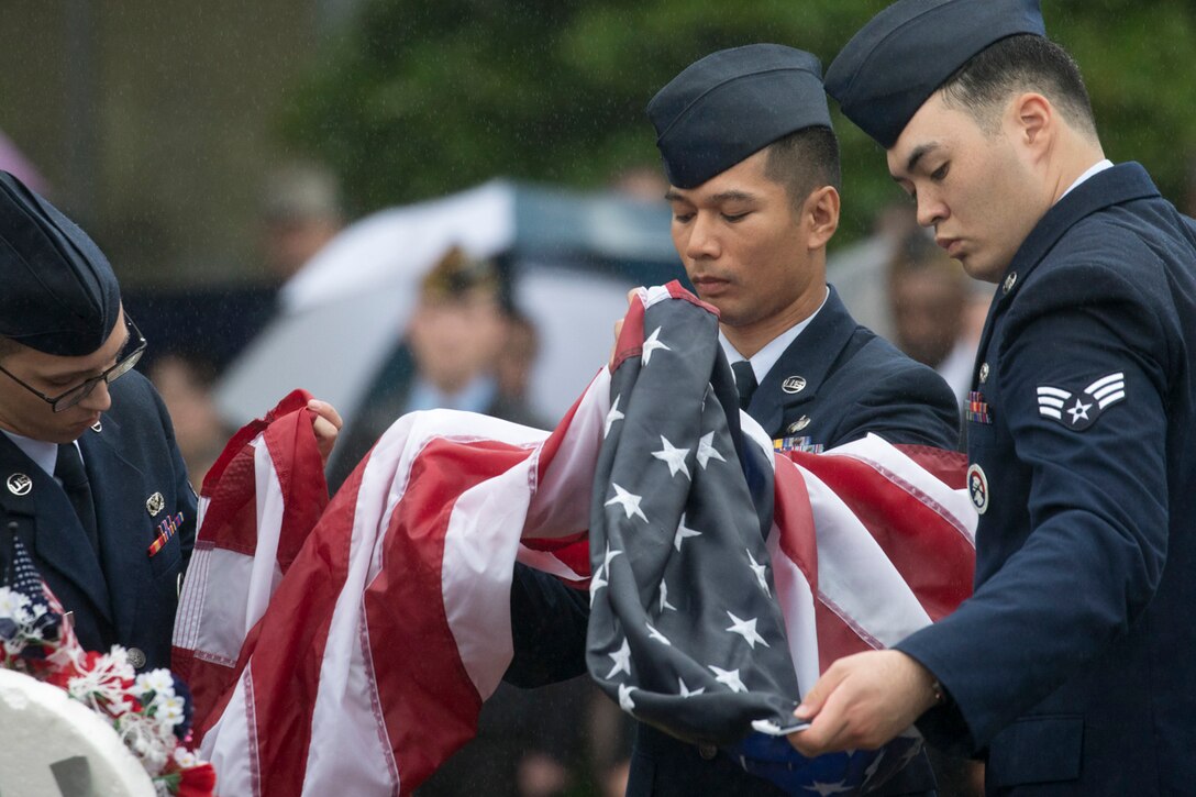 Yokota honor guardsmen fold the American flag during the Memorial Day ceremony at Yokota Air Base, Japan, May 26, 2017. The 374th Airlift Wing held the ceremony in memory of those who have given the ultimate sacrifice while in military service. (U.S. Air Force photo by Yasuo Osakabe)