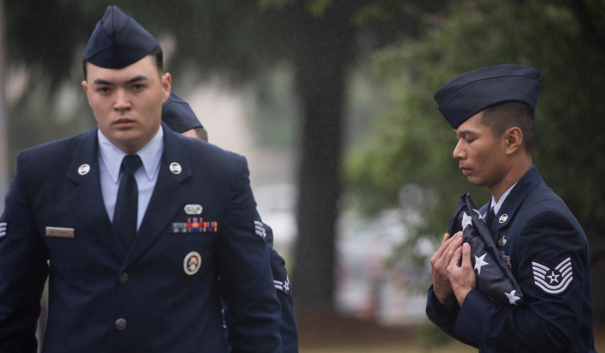 Tech. Sgt. Y Jin Ding Plai, right, Yokota honor guardsman, holds the American flag during the Memorial Day ceremony at Yokota Air Base, Japan, May 26, 2017. The 374th Airlift Wing held the ceremony in memory of those who have given the ultimate sacrifice while in military service. (U.S. Air Force photo by Yasuo Osakabe)