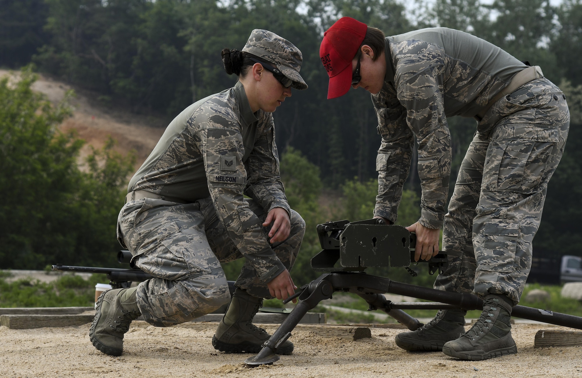 U.S. Air Force Staff Sgt. Catherine Nelson, 8th Security Forces Squadron Armory NCO in charge, and Staff Sgt. Kayla Hahn, 8th SFS Combat Arms instructor, set up an M2 machine gun during a weapons qualification training at Camp Rodriguez, Republic of Korea, May 23, 2017. Defenders from both the 51st and 8th SFSs participated in the training together to ensure both teams are ready to employ weapons systems at a moment’s notice. (U.S. Air Force photo by Airman 1st Class Gwendalyn Smith)