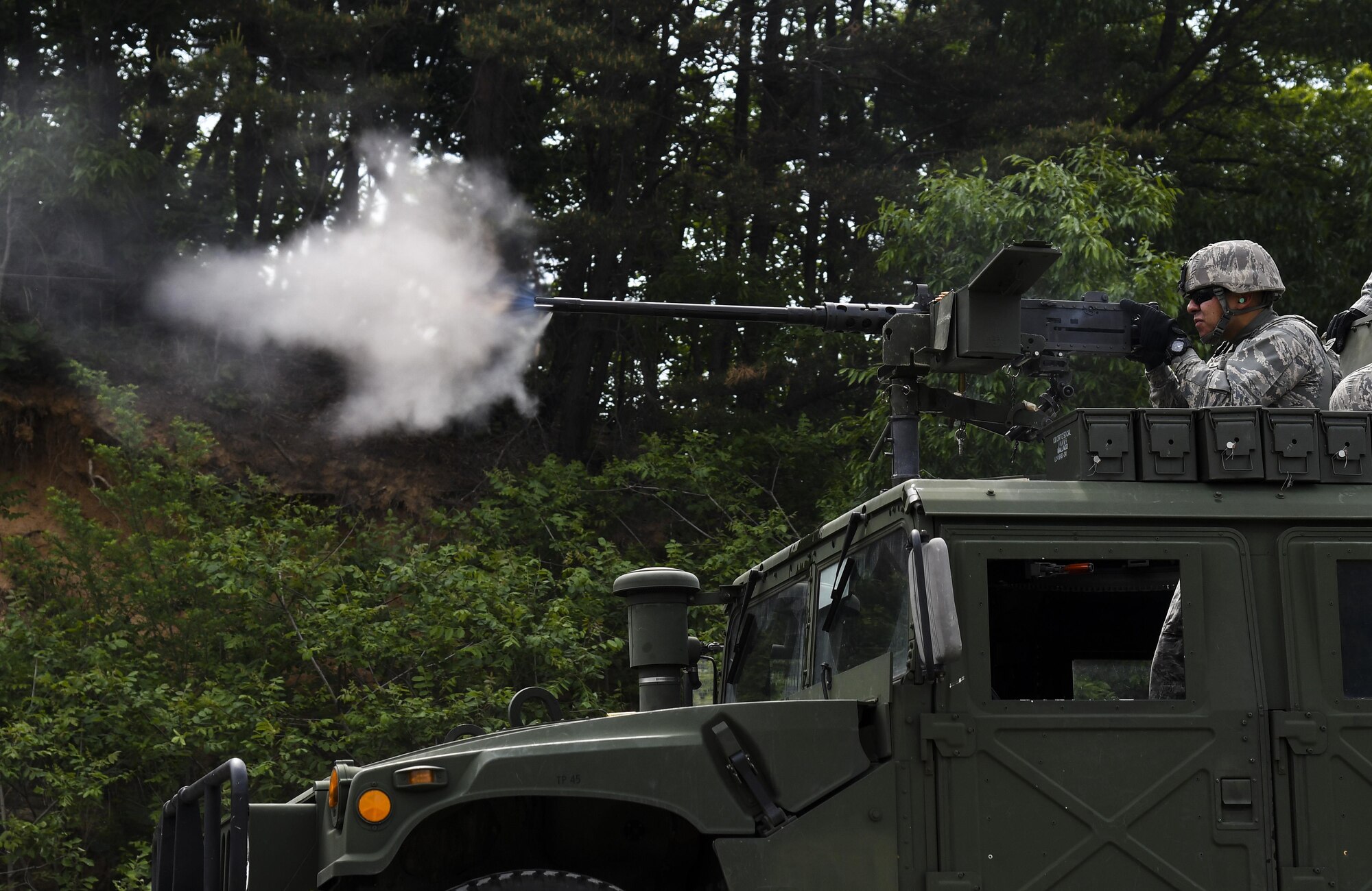 U.S. Air Force Airman Timothy Pushee, 8th Security Forces Squadron defender, fires an M2 machine gun during a weapons qualification training at Camp Rodriguez, Republic of Korea, May 23, 2017. Defenders participated in this training to become familiar and comfortable with these weapon systems. (U.S. Air Force photo by Airman 1st Class Gwendalyn Smith)