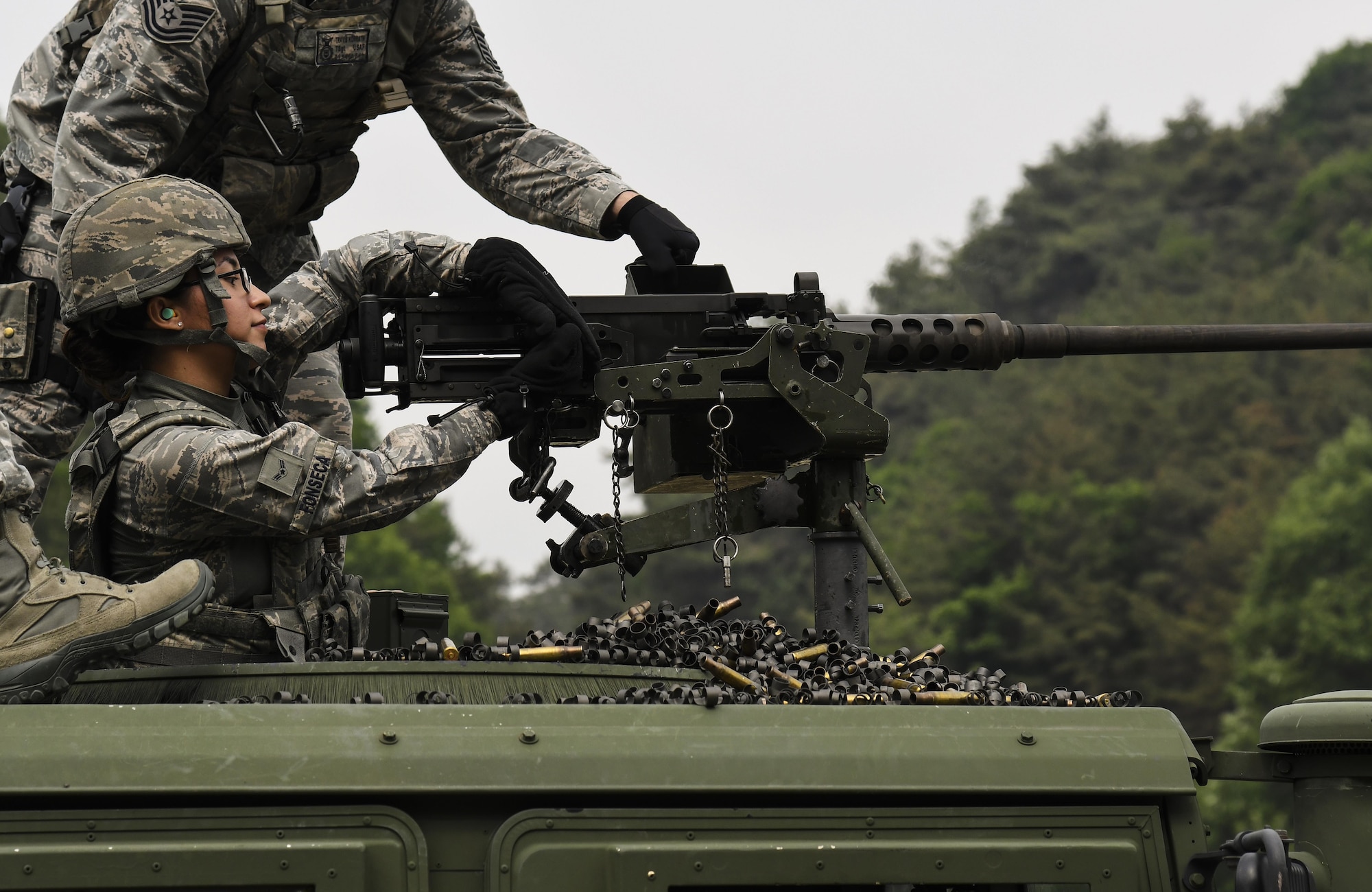 U.S. Air Force Airman 1st Class Jocelyn Fonseca, 8th Security Forces Squadron defender, charges the M2 machine gun during a weapons qualification training at Camp Rodriguez, Republic of Korea, May 23, 2017. Defenders from both the 51st and 8th SFSs participated in the training together to ensure both teams are ready to employ weapons systems at a moment’s notice. (U.S. Air Force photo by Airman 1st Class Gwendalyn Smith)