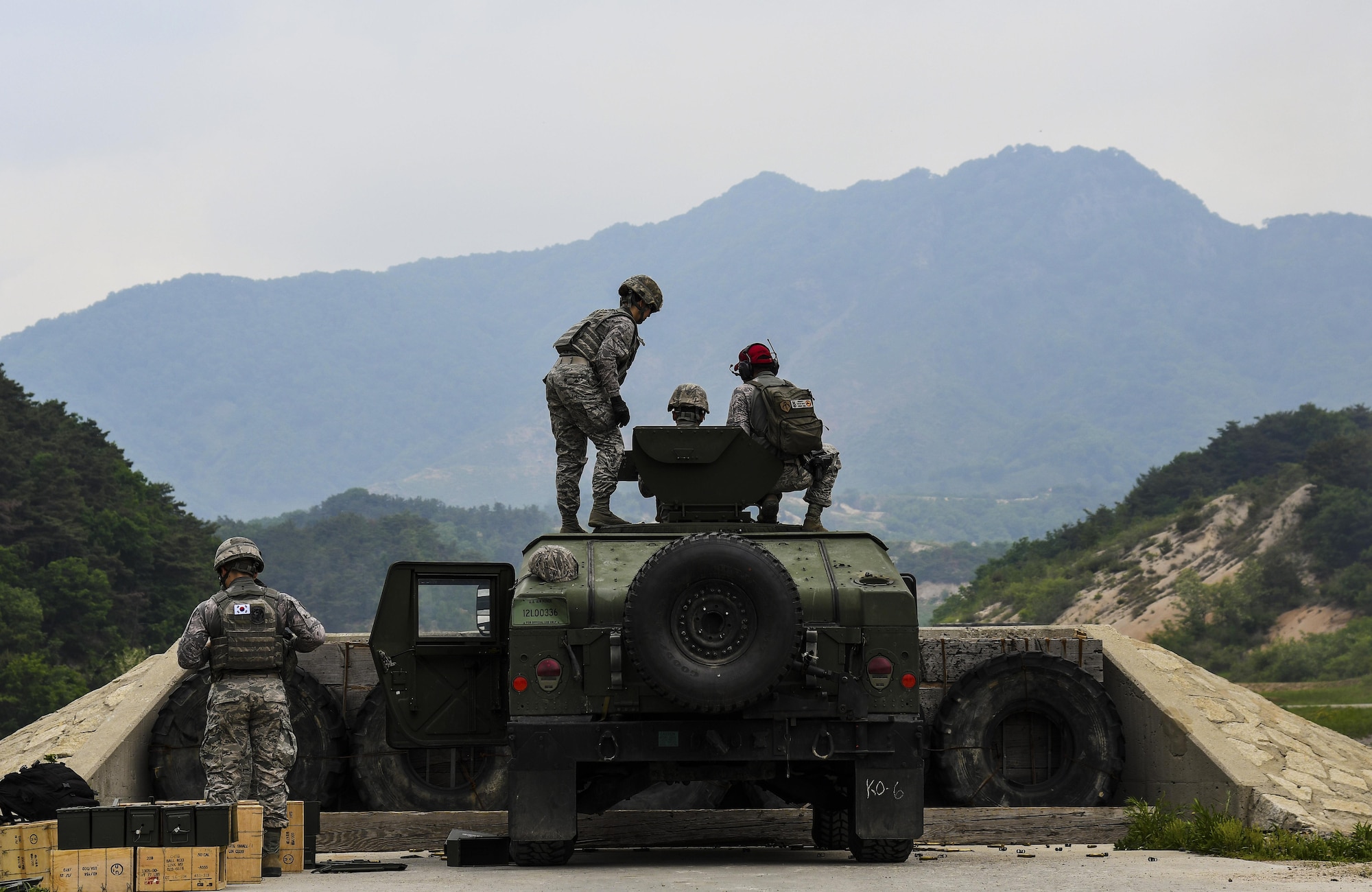 Defenders from the 51st and 8th Security Forces Squadrons participate in weapons training at Camp Rodriguez, Republic of Korea, May 23, 2017. During the training, Defenders qualified on the MK-19 grenade launcher, M2 machine gun and the M24 sniper rifle. (U.S. Air Force photo by Airman 1st Class Gwendalyn Smith)