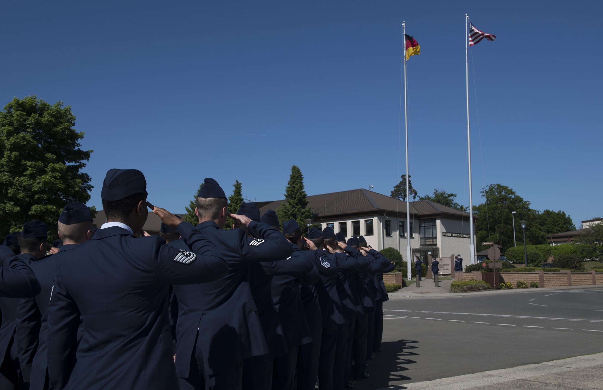 U.S. Air Force Airmen assigned to the 86th Operations Group salute while the German flag is lowered during a Memorial Retreat Ceremony on Ramstein Air Base, Germany, May 26, 2017. Memorial Day commemorates all the U.S. men and women who have died in service of their country. (U.S Air Force photo by Senior Airman Tryphena Mayhugh)