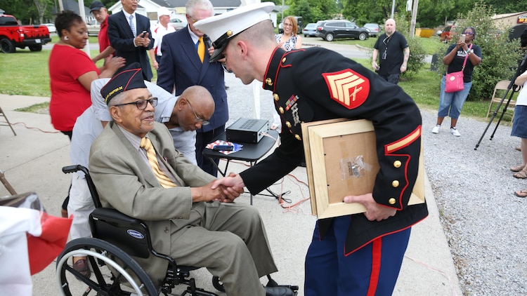 Sergeant Mike Stachowski greets Archibald Mosley, May 27, at the Colp Area Veterans Celebration, Dedication and Remembrance Ceremony, in Colp, Illinois. The ceremony honored fallen service members, Mosley and three other African American Marines from Colp, who were among the first black Americans to join Marine Corps during World War II. They became known as the Montford Point Marines. Nearly 20,000 African-Americans joined the Marine Corps in 1942, after President Franklin D. Roosevelt issued a “presidential directive giving African Americans an opportunity to be recruited in the Marine Corps,” according to the Montford Point Marines Association website. They didn’t receive recruit training at San Diego or Parris Island, however, but Camp Montford Point, N.C., a segregated training site for African American Marine recruits. For the next seven years, the camp remained opened until it became desegregated. The four Marines are Sol Griffin, Jr.; James L. Kirby, Early Taylor, Jr. and Archibald Mosley. These Marines, among many other Montford Point Marines across the country, were awarded the Congressional Gold Medal, the highest award that can be given to a civilian by Congress, in 2012. 