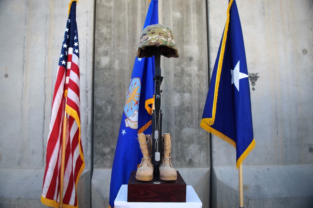 A battlefield cross is displayed during a Memorial Day ceremony at Bagram Airfield, Afghanistan, May 29, 2017. The boots, rifle and helmet make what is called the Battlefield Cross, which is a symbolic replacement of a cross and is used to honor and show respect to deceased service members. Air Force photo by Staff Sgt. Benjamin Gonsier