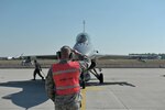 Master Sgt. Joe Ray, a weapons loader assigned to the 180th Fighter Wing, monitors a final preflight safety check on an F-16 Fighting Falcon, May 29, 2017, at Kecskemet Air Base in Hungary. 