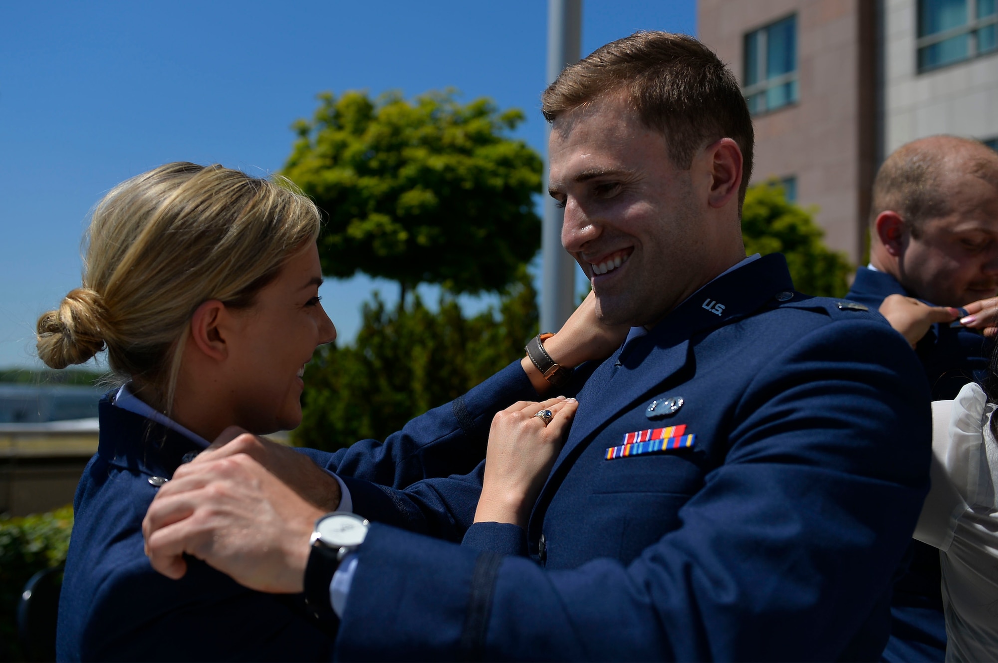 U.S. Air Force Capts. Haley Wilson, 603rd Air Operations Center strategy division officer, left, and Kevin Durr, Warrior Preparation Center program manager, pin their new ranks on each other during their promotion ceremony on Ramstein Air Base, Germany, May 26, 2017. The ceremony was presided over by Lt. Gen. Richard M. Clark, 3rd Air Force commander. (U.S. Air Force photo by Airman 1st Class Joshua Magbanua) 
