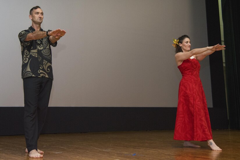 11th Security Forces Group commander, Col. Troy Roberts and his wife, Jenny Roberts, perform a hula dance during the Asian American and Pacific Islander Heritage Month Culture Show at Joint Base Andrews, Md., May 24, 2017. The month-long observance was signed into law from a week to a month by the 41st U.S. President, George H.W. Bush, in 1992, and from that year forward, congress permanently designated May as AAPIHM. (U.S. Air Force photo by Airman 1st Class Valentina Lopez)