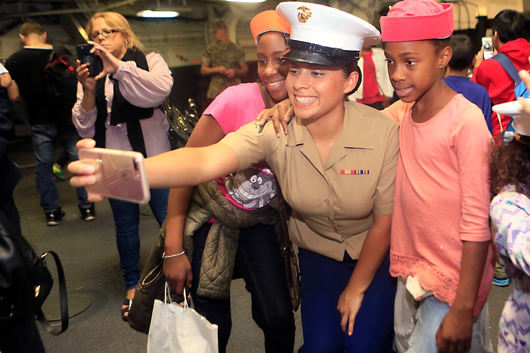 A Marine takes a selfie with two children during a tour aboard the USS Kearsarge as part of Fleet Week New York in New York City, May 27, 2017. Marines, sailors, and Coast Guardsmen chaperoned 20 children participating in the 11th Annual Project Hope. Marine Corps photo by Sgt. Gabby Petticrew