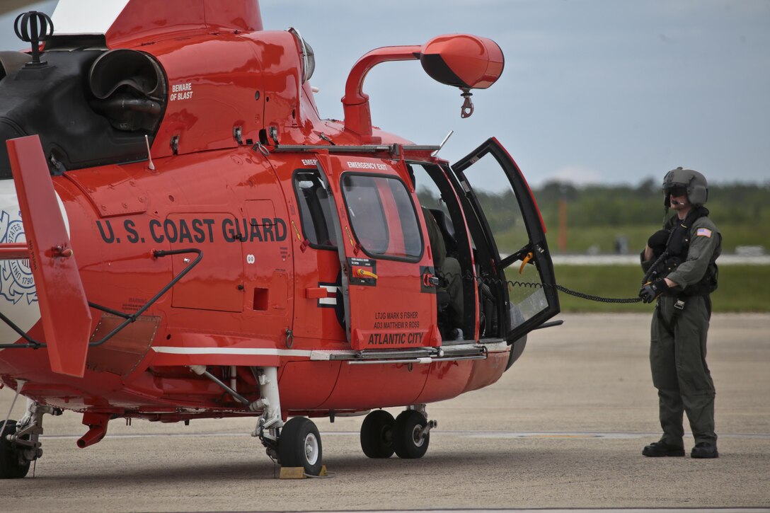 A U.S. Coast Guard HH-65C Dolphin crew chief from Coast Guard Air Station Atlantic City preps the aircraft for takeoff after an alert during a three-day Aeropsace Control Alert CrossTell live-fly training exercise at Atlantic City International Airport, N.J., May 24, 2017. Representatives from the Air National Guard fighter wings, Civil Air Patrol, and U.S. Coast Guard rotary-wing air intercept units will conduct daily sorties from May 23-25 to hone their skills with tactical-level air-intercept procedures. (U.S. Air National Guard photo by Master Sgt. Matt Hecht/Released)