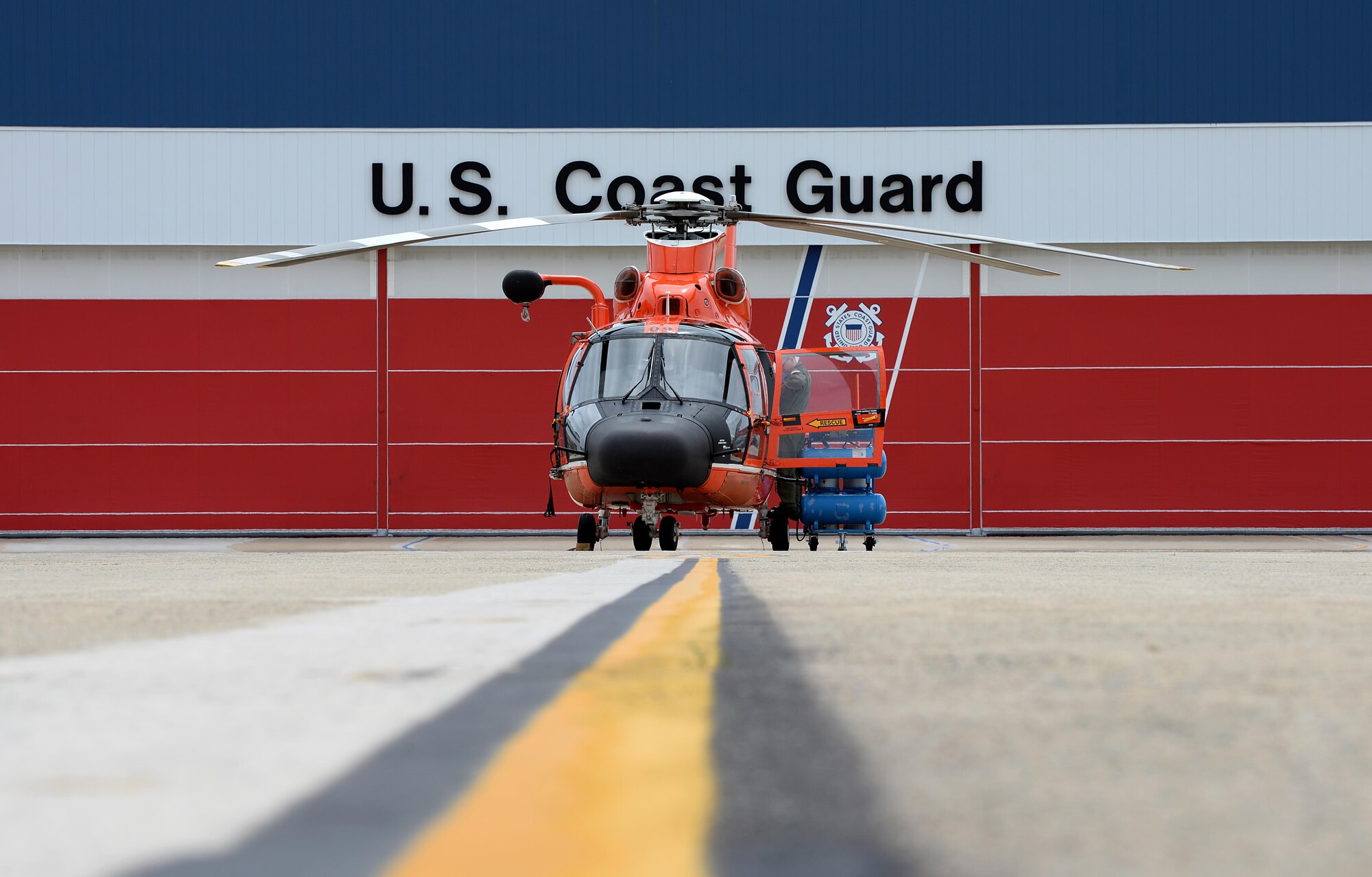A U.S. Coast Guard HH-65C Dolphin crew member from Coast Guard Air Station Atlantic City preps his helicopter before an alert during a CrossTell training exercise at the Atlantic City International Airport, N.J., May 24, 2017. Air National units from New Jersey, South Carolina and Washington D.C. participated in training and familiarization exercises with the U.S. Coast Guard and Civil Air Patrol during the three-day CrossTell to increase awareness of the Aerospace Control Alert mission. (U.S. Air National Guard photo by Airman 1st Class Cristina J. Allen/Released)