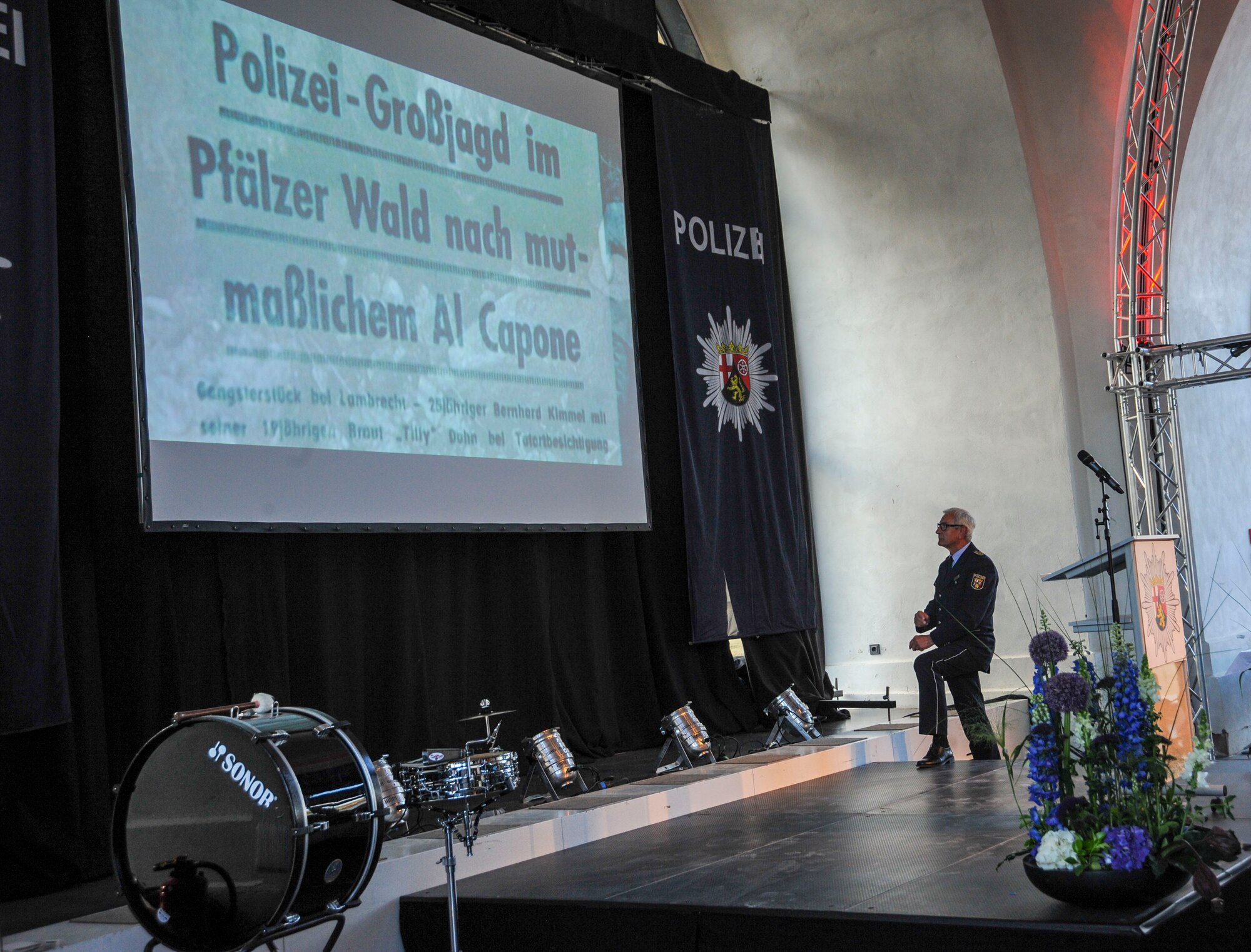 Police Inspector Jürgen Schmitt, Rhineland-Palatinate (RLP) Polizei, looks at a headline about the Polizei’s work during the RLP Polizei’s 70th year anniversary celebration in Koblenz, Germany, May 20, 2017. Forming alongside RLP, the RLP Polizei initially combated black markets and gang activity after World War II. Now, they are more partners of politics, economics, most importantly the people. (U.S. Air Force photo by Staff Sgt. Timothy Moore)