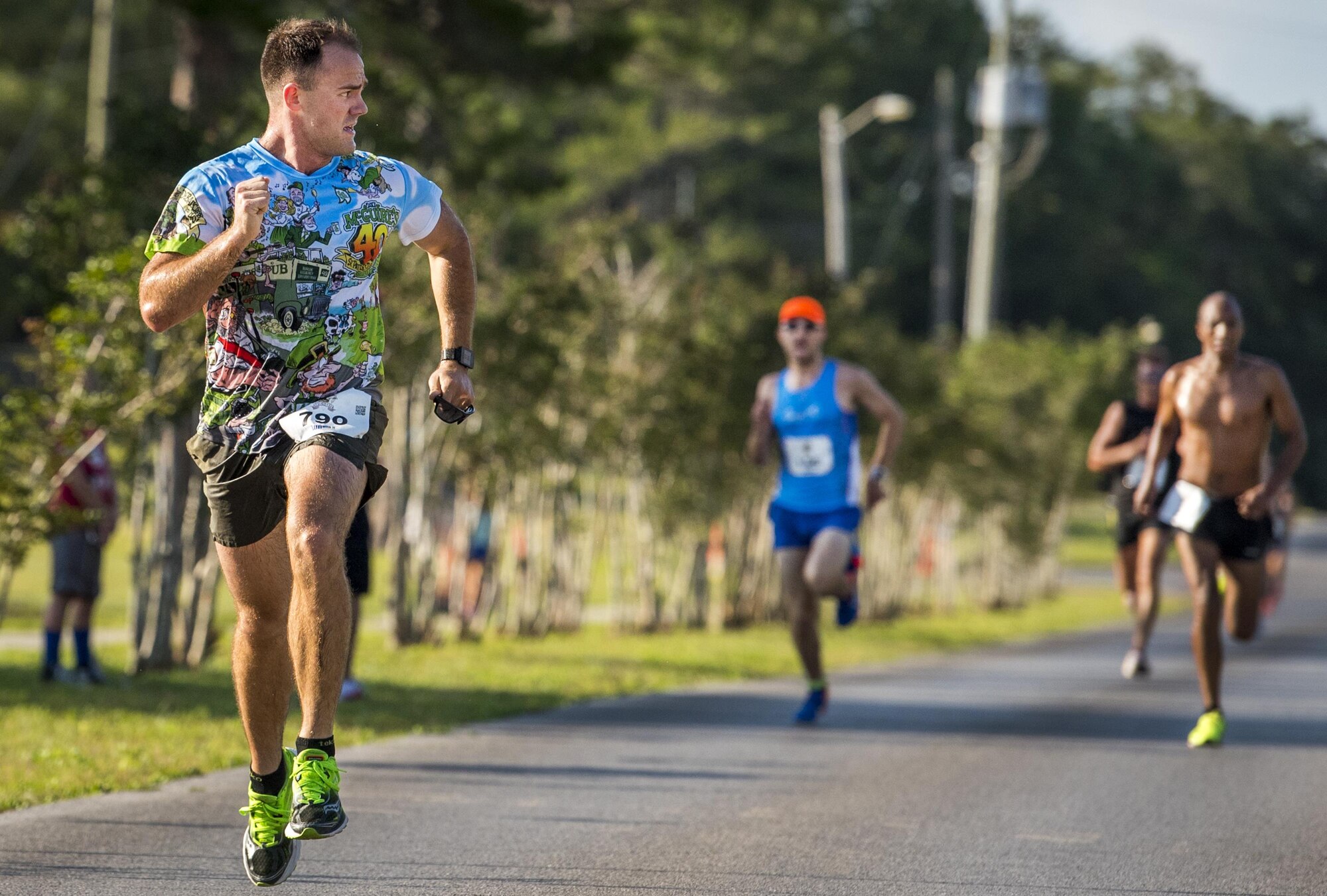 Ben Jones checks his six as he speeds toward the finish line of the 32nd annual Gate to Gate run at Eglin Air Force Base, Fla., May 27.  Jones finished fifth in the race at 26 minutes 42 seconds and best in his age group.  More than 900 people participated at this year’s event.  (U.S. Air Force photo/Samuel King Jr.)