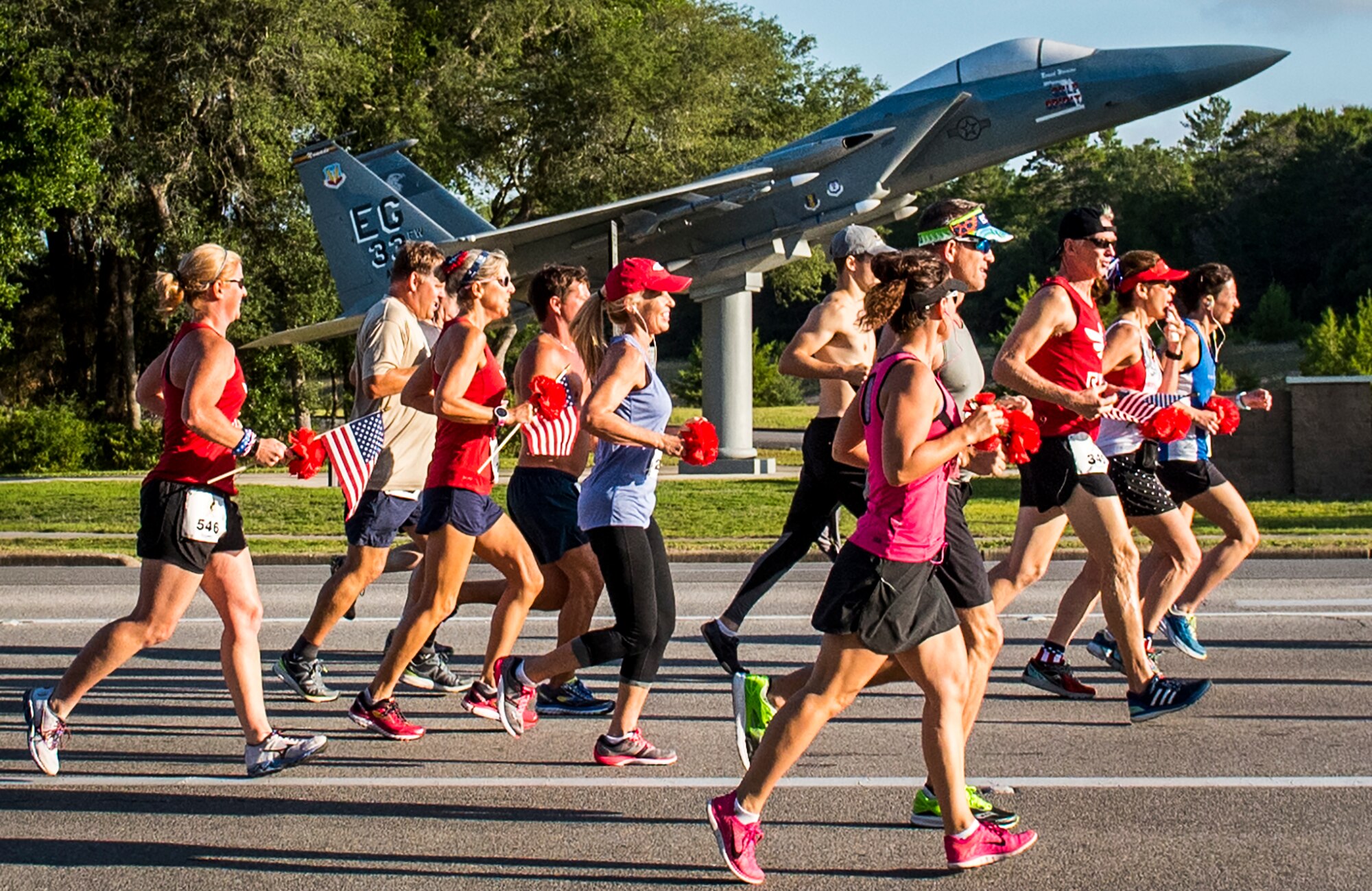 Runners jog by the 33rd Fighter Wing’s F-15 static display at the 32nd annual Gate to Gate run at Eglin Air Force Base, Fla., May 27.  More than 900 people participated at this year’s event.  (U.S. Air Force photo/Samuel King Jr.)