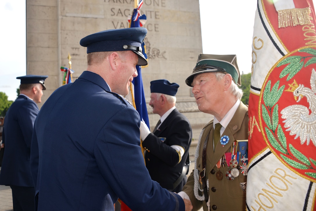 Air Force Gen. Tod D. Wolters, left, commander of U.S. Air Forces in Europe and Air Forces Africa, greets a French ﬂag bearer during a Memorial Day ceremony at the Arc de Triomphe in Paris, May 28, 2017. Air Force photo by Capt. Ben Sowers