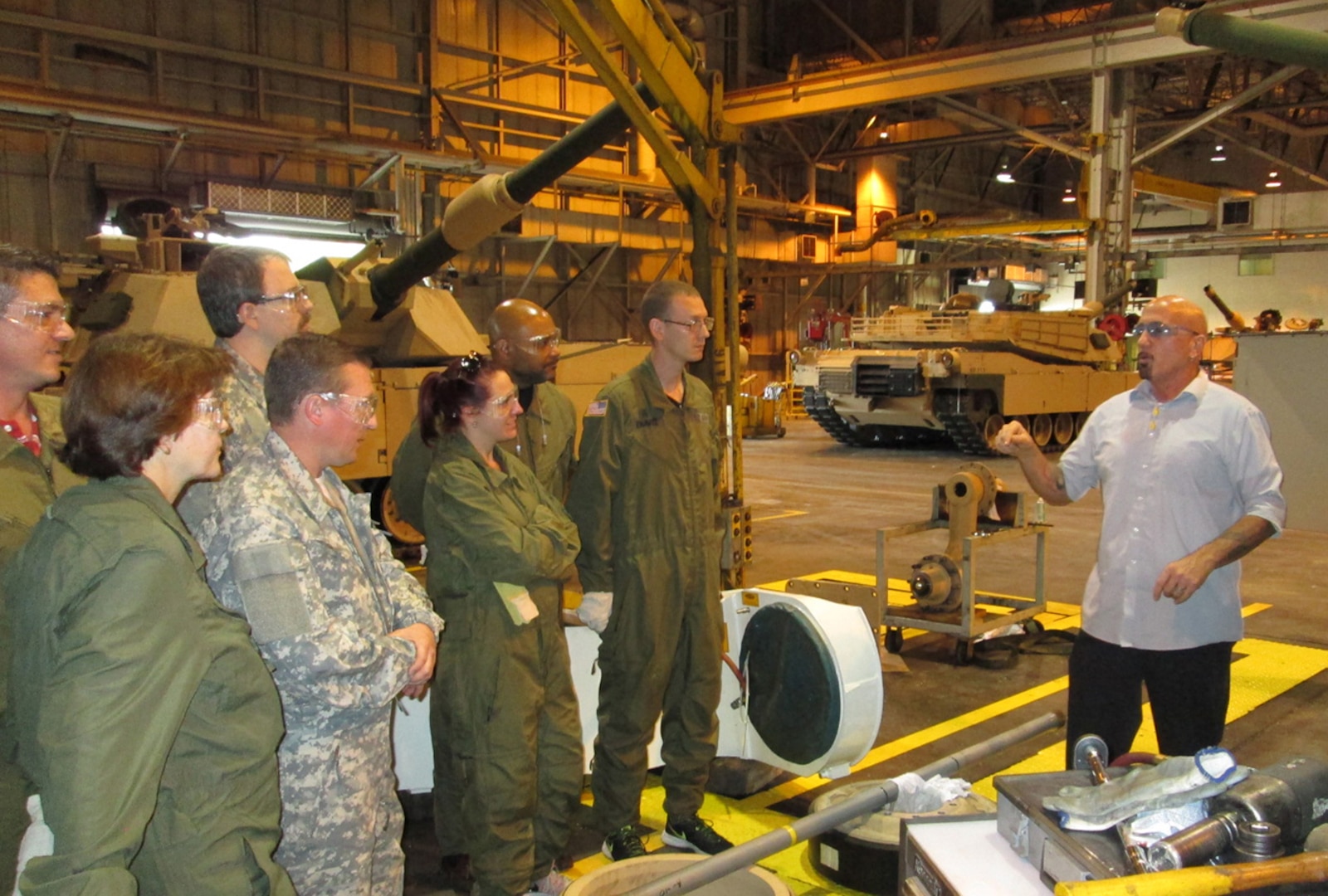 A group of DLA Land and Maritime associates listen to David Hobbs (right), a quality assurance specialist at the Joint Systems Manufacturing Center in Lima, Ohio as he explains the production process of an Abrams Main Battle Tank. The group toured the facility May 16-17 to learn about the production of combat vehicles.