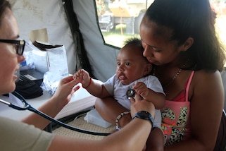 U.S. Air Force Maj. Crystal Palmatier, a pediatrician with the 96th Medical Support Group from Eglin Air Force Base, Florida, checks a patient's heart beat at a medical readiness event in Dangriga, Belize, May 22, 2017. This is the third and final medical event scheduled for Beyond the Horizon 2017, a U.S. Southern Command-sponsored, Army South-led exercise designed to provide humanitarian and engineering services to communities in need, demonstrating U.S. support for Belize. (U.S. Army photo by Spc. Kelson Brooks) (RELEASED)