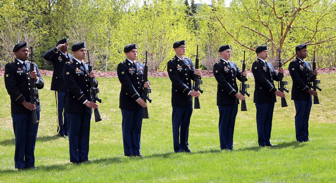 Soldiers present arms during the playing of taps at a Memorial Day ceremony at Fort Richardson National Cemetery on Joint Base Elmendorf-Richardson, Alaska, May 29, 2017. The soldiers are assigned to the 307th Expeditionary Signal Battalion. Army photo by Mary M. Rall