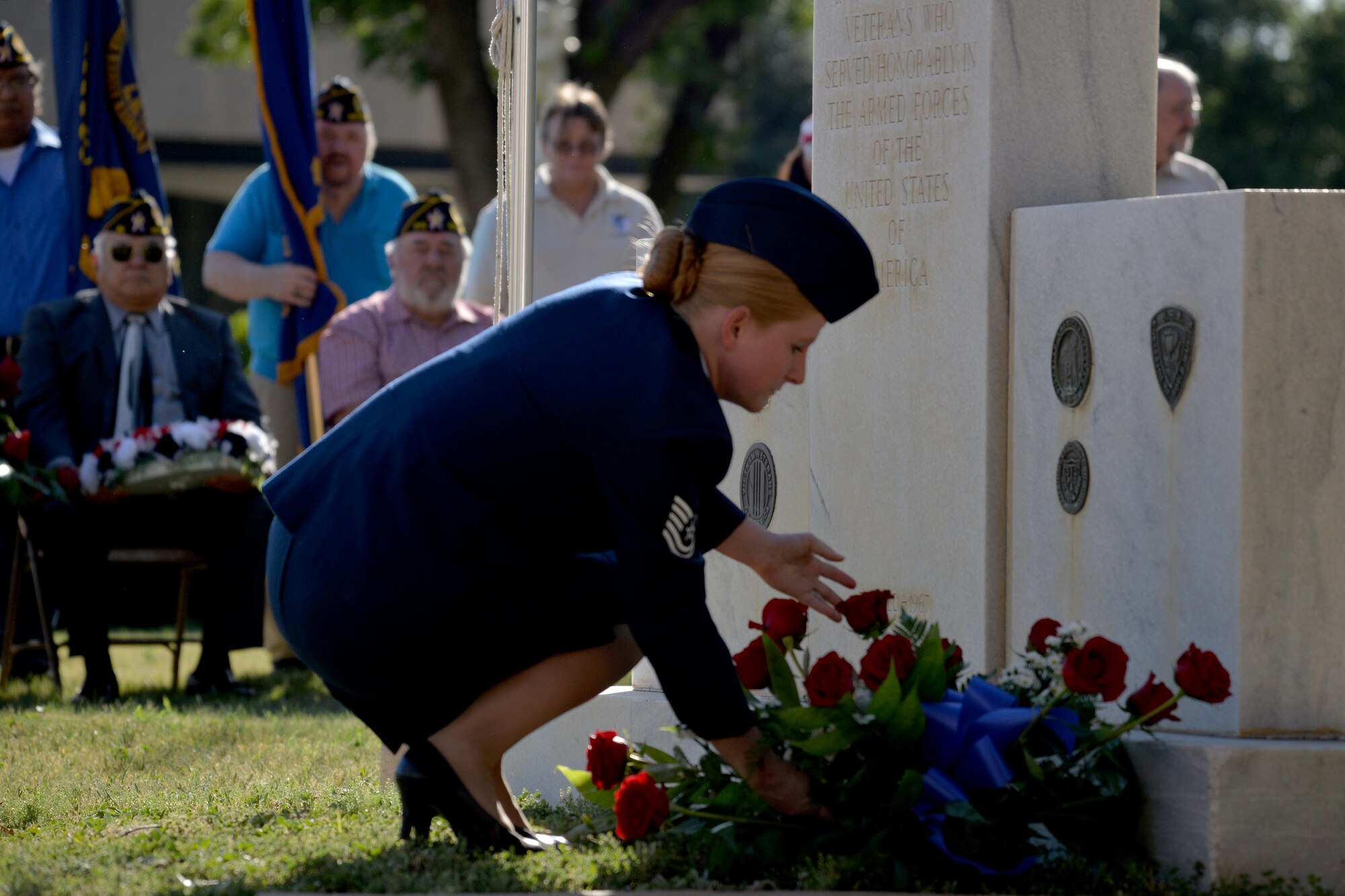 U.S. Air Force Tech. Sergeant Jessi Baugh, 17 Medical Support Squadron command support staff NCO in charge, places a wreath upon the veteran memorial during the Memorial Day Ceremony at the Tom Green County Courthouse in San Angelo, Texas, May 29, 2017. At the end of the ceremony, members of local veterans' organizations also placed wreaths on the veteran memorial near the courthouse and four retired service members from the All Veterans Council lowered the flag during "Taps." (U.S. Air Force photo by Airman 1st Class Randall Moose/Released)