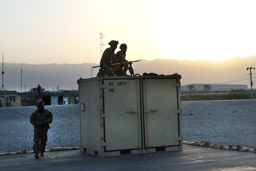 Soldiers prepare to hook-up a container to a CH-47 Chinook helicopter during slingload operations at Bagram Airfield, Afghanistan, May 22, 2017. Army photo by Sgt. 1st Class Shelia Cooper
