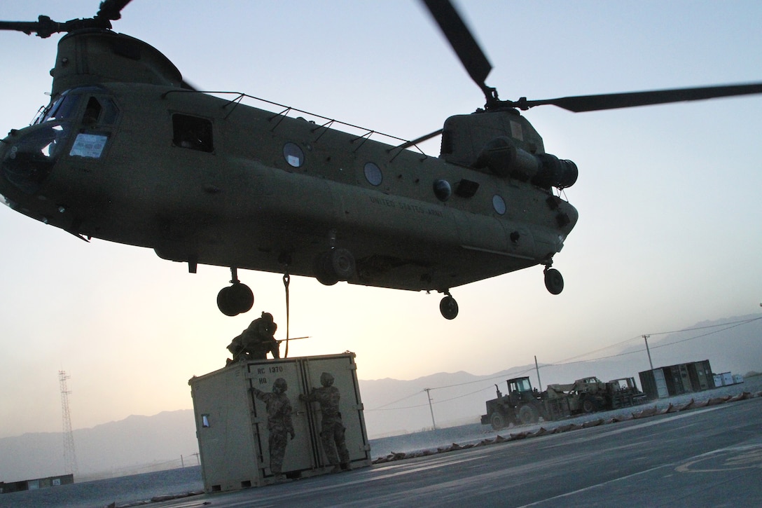 Soldiers hook-up a container to a CH-47 Chinook helicopter during slingload operations at Bagram Airfield, Afghanistan, May 22, 2017. 
Army photo by Sgt. 1st Class Shelia Cooper

