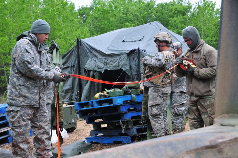 Soldiers with the 993rd Transportation Company from Palatka, Florida, wrap up cargo tie-down straps after unloading supplies during Maple Resolve 17 at Camp Wainwright, Alberta, Canada, on May 24, 2017.  The 993rd provided logistical support during the Canadian Army’s premier brigade-level validation exercise designed to sharpen individual skill sets and enhance unit readiness. (U.S. Army photo by Sgt. Sarah Zaler)