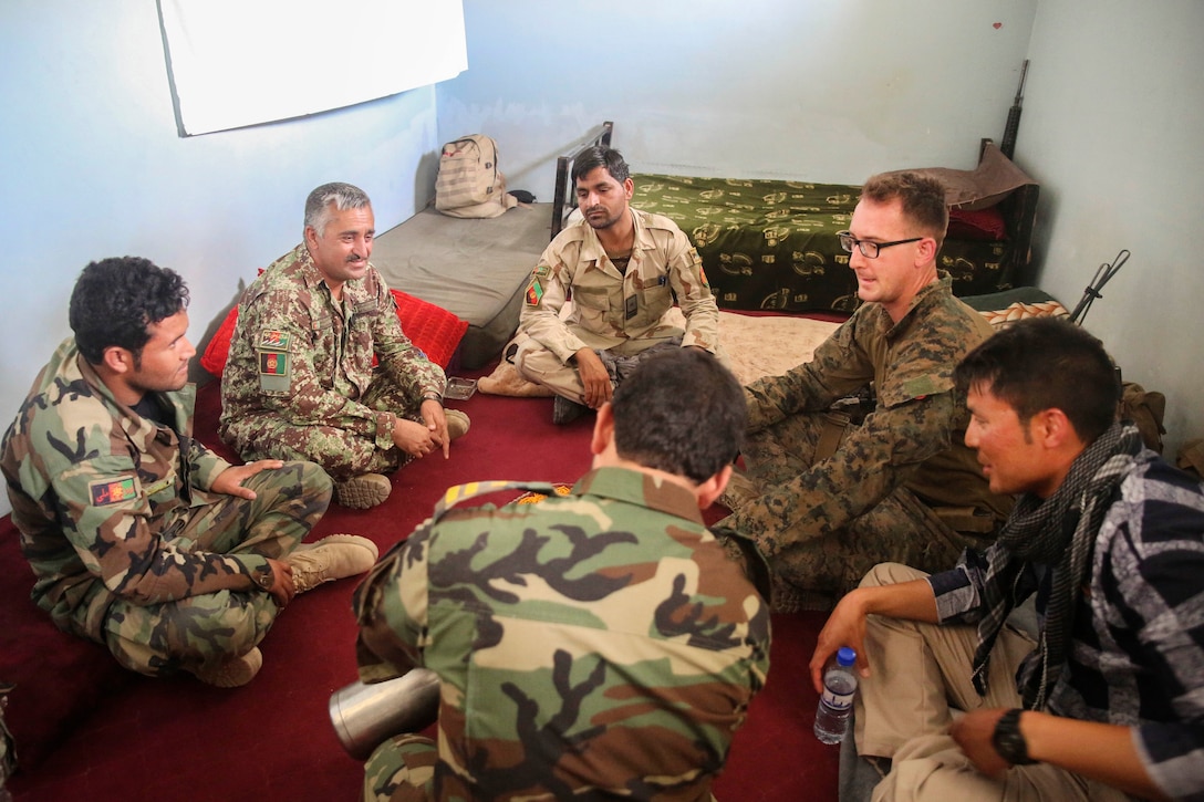 A U.S. Marine, second from right, speaks to Afghan soldiers regarding artillery capabilities at Camp Nolay, Afghanistan, May 22, 2017. The Afghan soldiers are assigned to the 2nd Brigade, 215th Corps. Marine Corps photo by Sgt. Lucas Hopkins