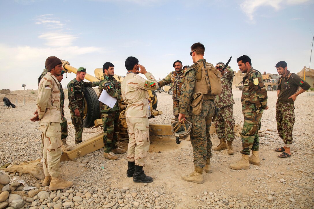 A U.S. Marine, center right, speaks with Afghan soldiers on artillery capabilities and tactics at Camp Nolay, Afghanistan, May 22, 2017. Marine Corps photo by Sgt. Lucas Hopkins