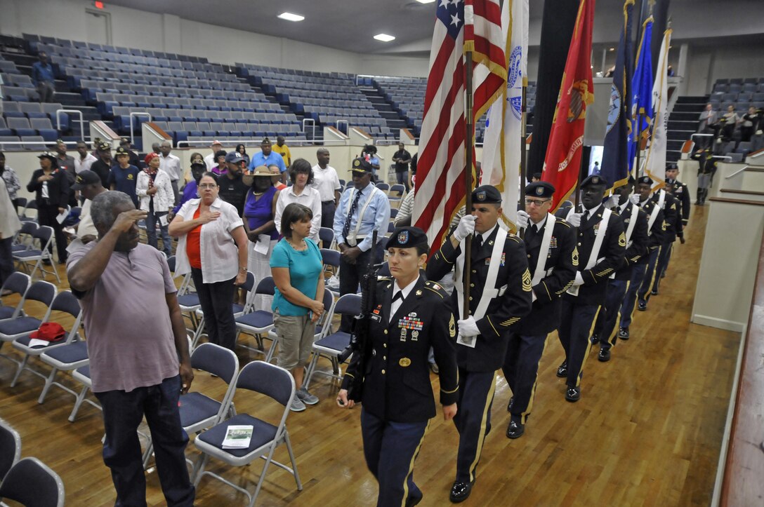 U.S. Army Reserve Master Sgt. Kimberly Jones, leads a Color Guard of the Headquarters and Headquarters Company, 412th Theater Engineer Command, based in Vicksburg, Miss., as it posts the Colors during the 38th-annual Memorial Day Memorial Service in the Vicksburg City Auditorium May 29, 2017. The Color Guard is 1st Sgt. Richard Broussard, Capt. Adam Corley, Master Sgt. Michael Christy, Sgt. 1st Class Cornelius Joyner , Staff Sgt. Bollis, Sgt. 1st Class Jeremy Reed, Sgt. Gustavo Salazar, Sgt. 1st Class Laverne Cohill and Capt. Adam Corley. (U.S. Army Reserve Photo by Sgt. 1st Class Clinton Wood).